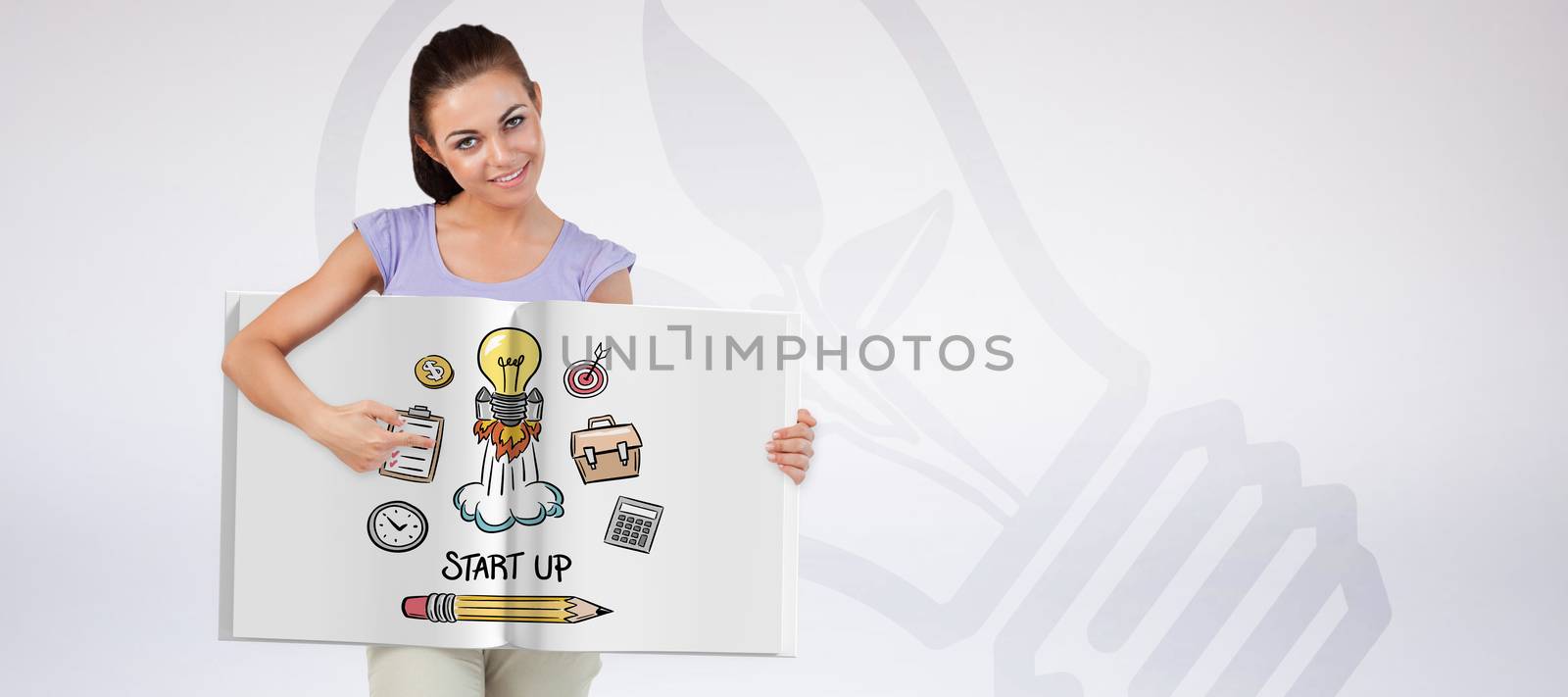 Pretty woman showing a book against grey background