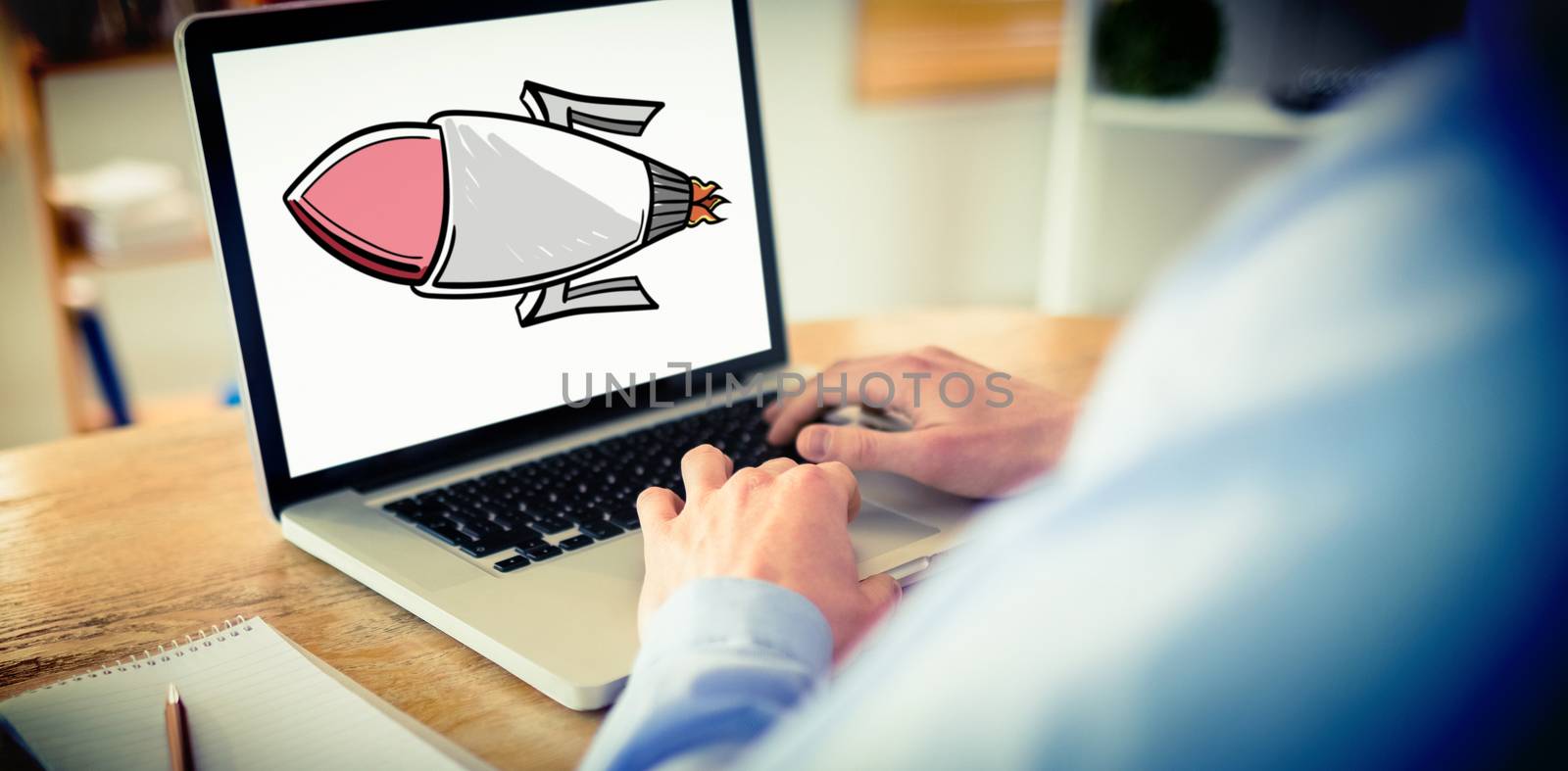 Composite image of businessman working on his laptop by Wavebreakmedia