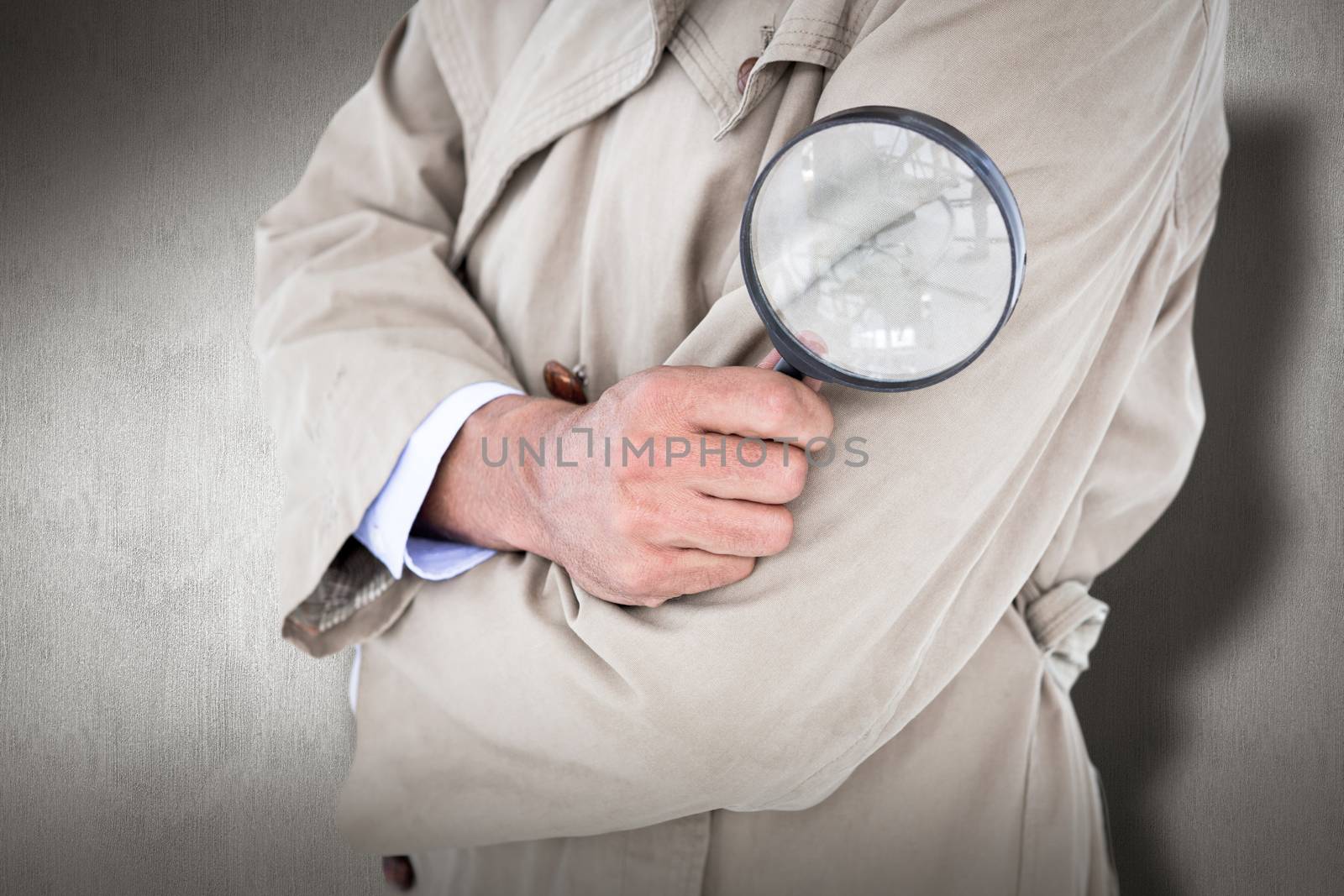 Spy looking through magnifier against white and grey background