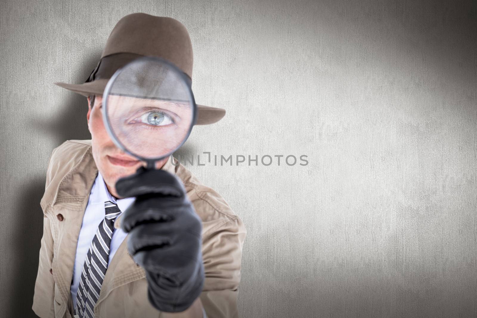 Spy looking through magnifier against white and grey background