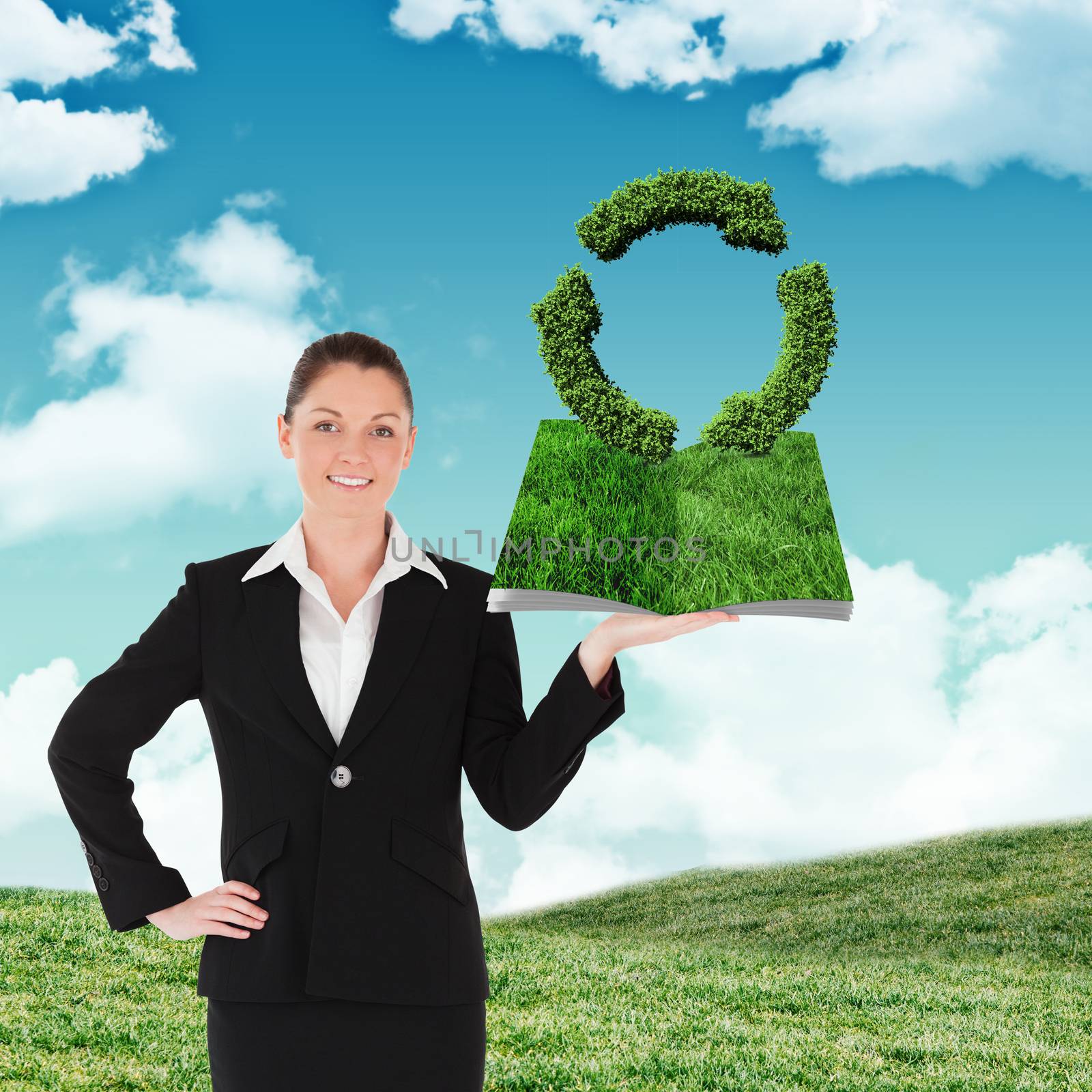 Woman holding lawn book against blue sky over green field