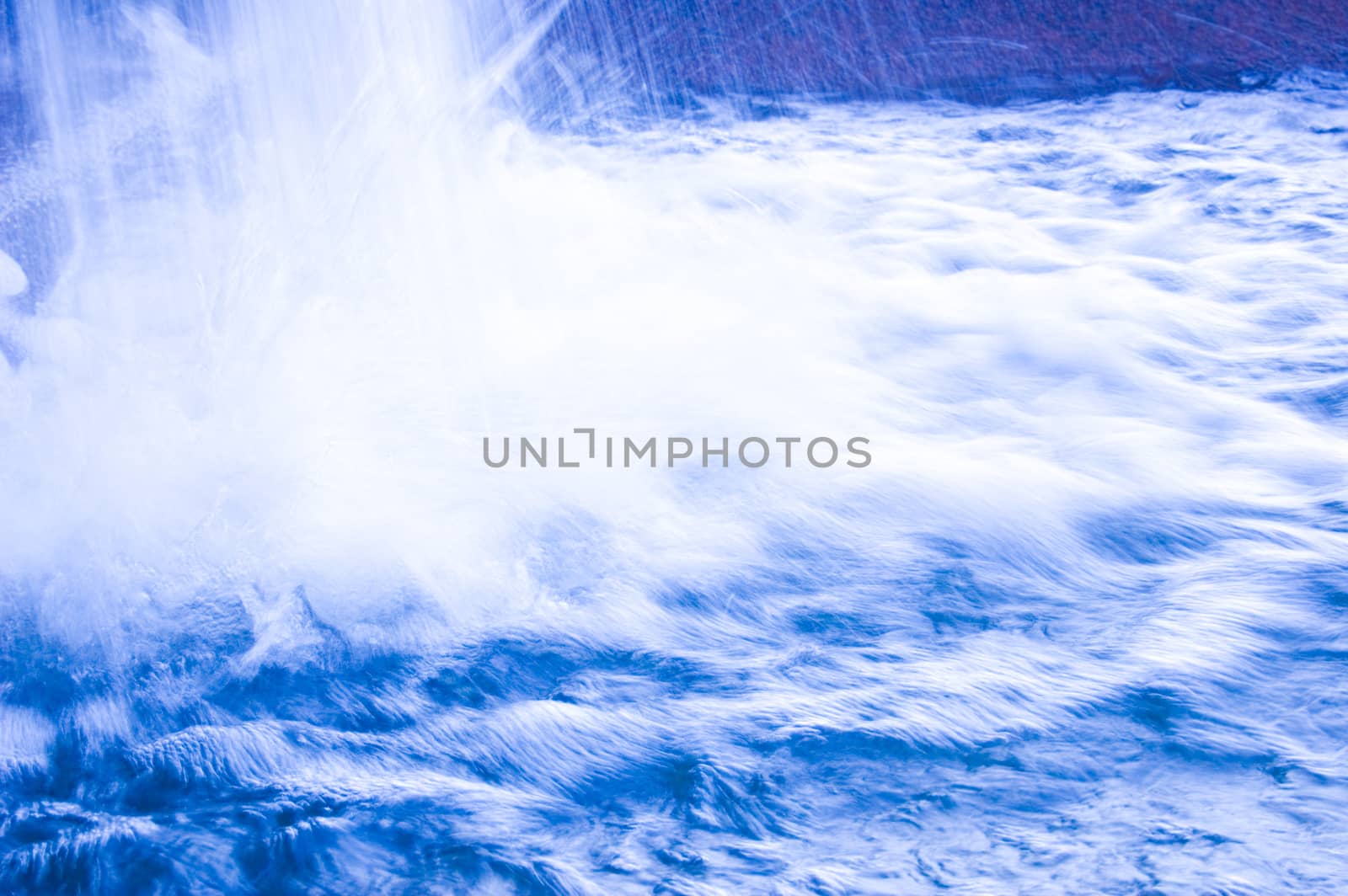 Nature conceptual image. Motion picture of fresh, blue water in waterfall.