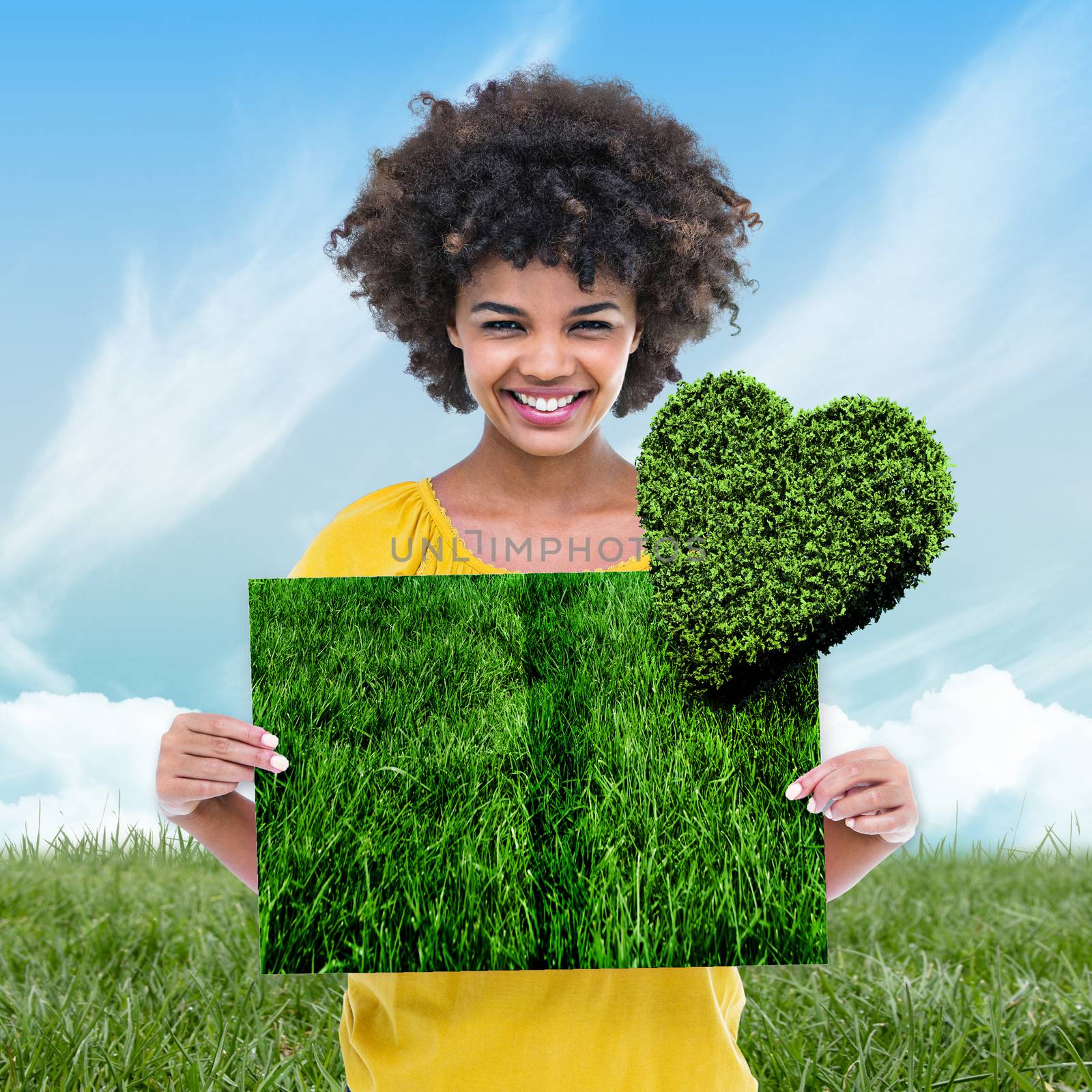 Woman holding lawn book against blue sky over green field