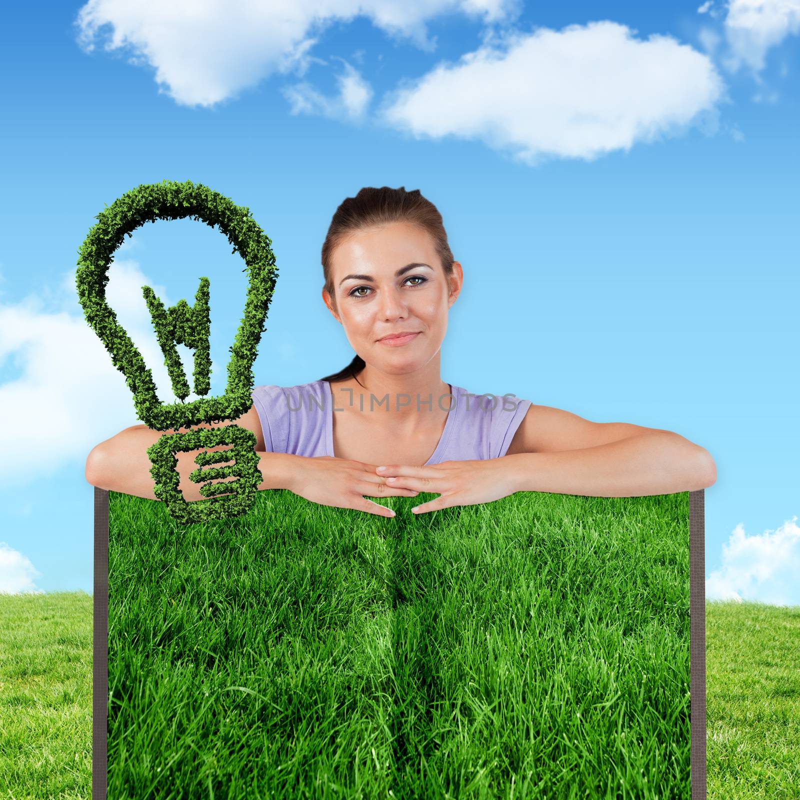 Woman with lawn book against blue sky over green field