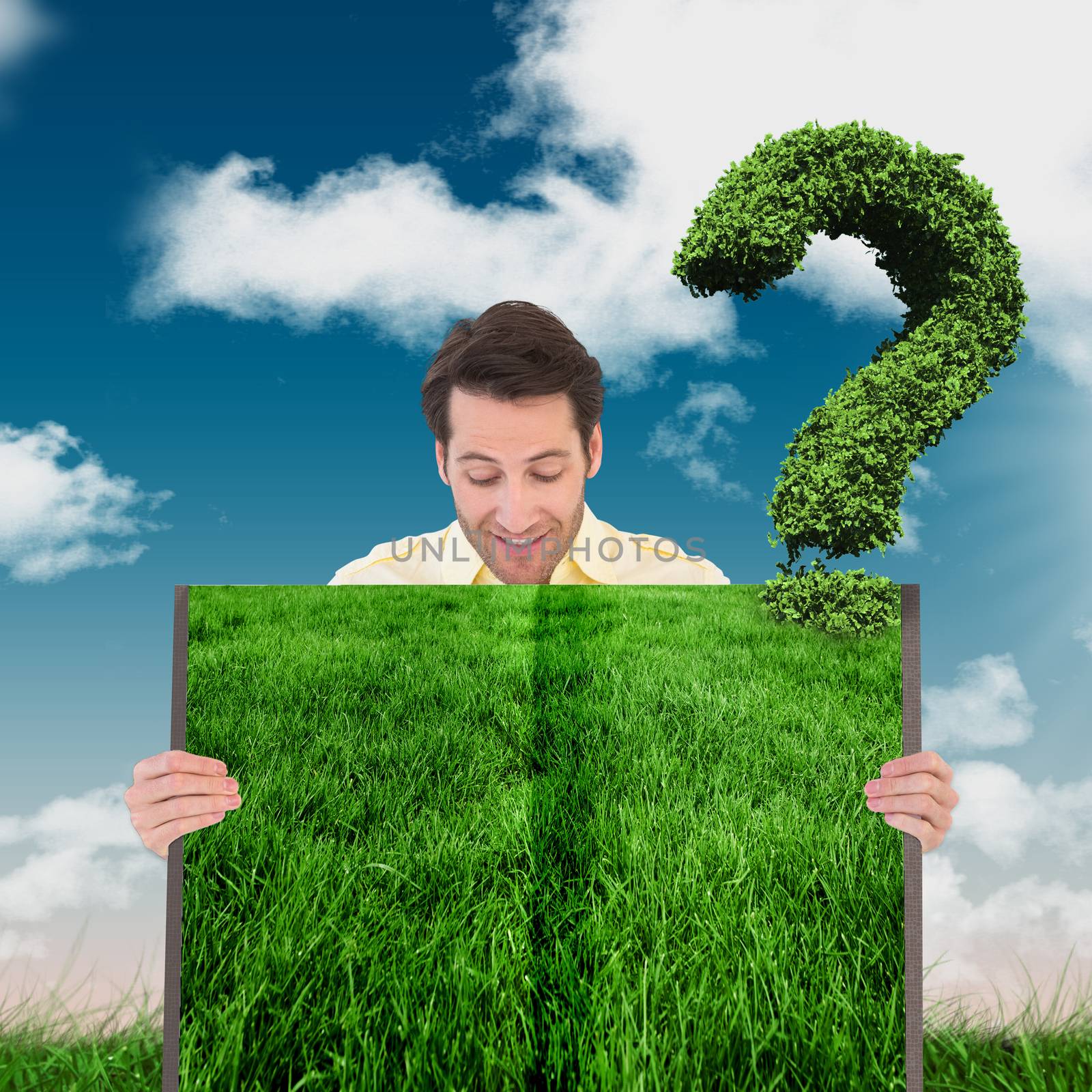 Man holding lawn book against green field under blue sky