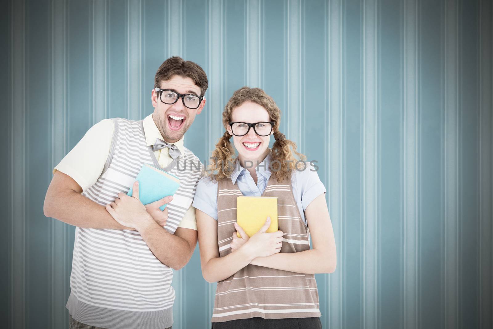 geeky hipster couple holding books and smiling at camera  against background