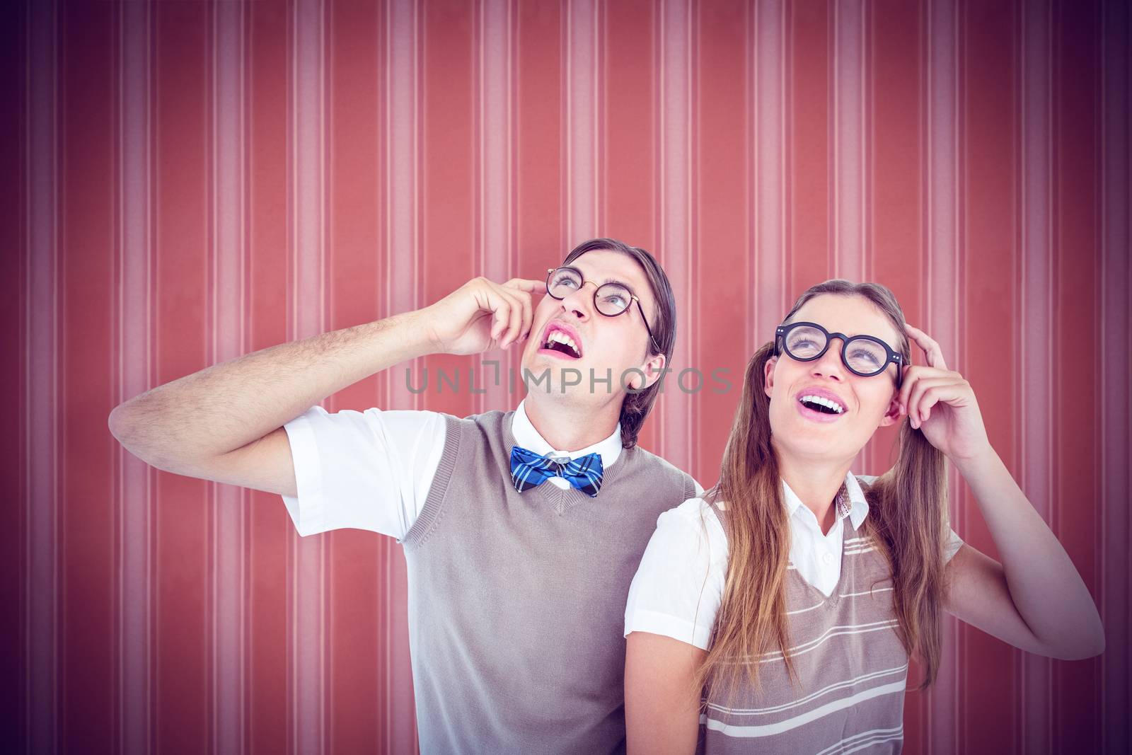 Geeky hipsters looking confused  against background