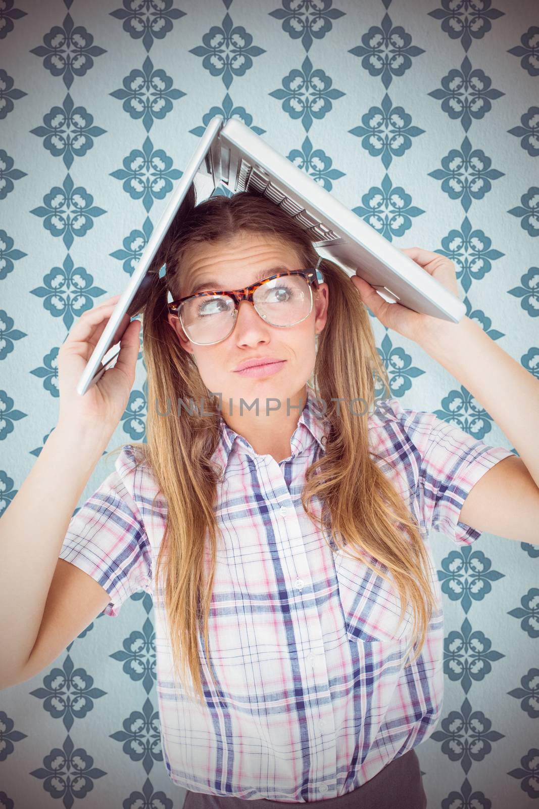 Composite image of geeky hipster holding her laptop over her head  by Wavebreakmedia