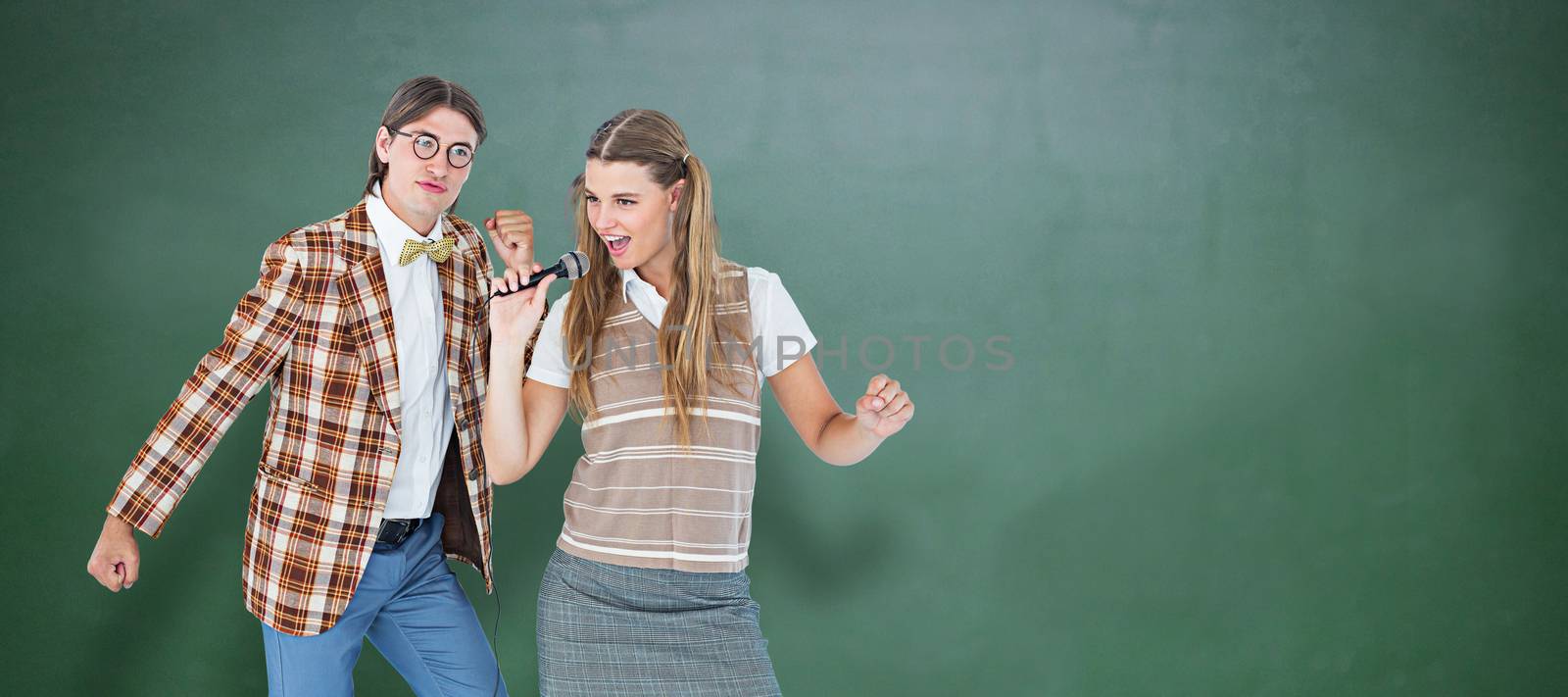 Composite image of happy geeky hipsters singing with microphone by Wavebreakmedia