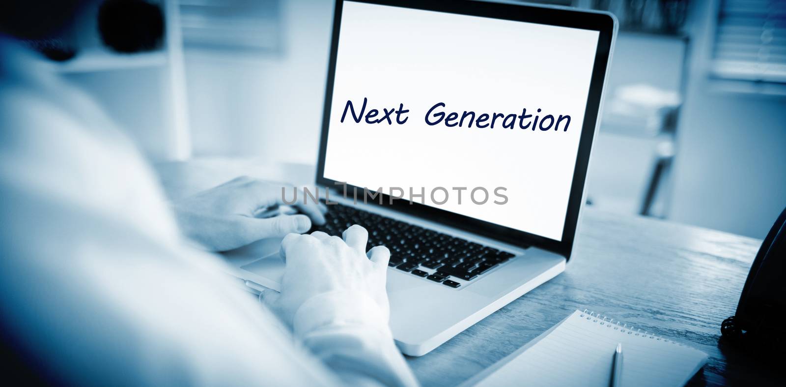Next generation against businessman working on his laptop by Wavebreakmedia