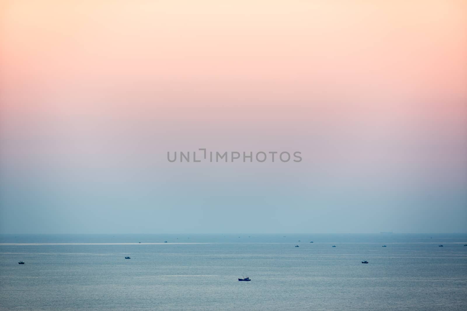 Small fishing boats in South China Sea at dusk, Mui Ne, Vietnam by fisfra