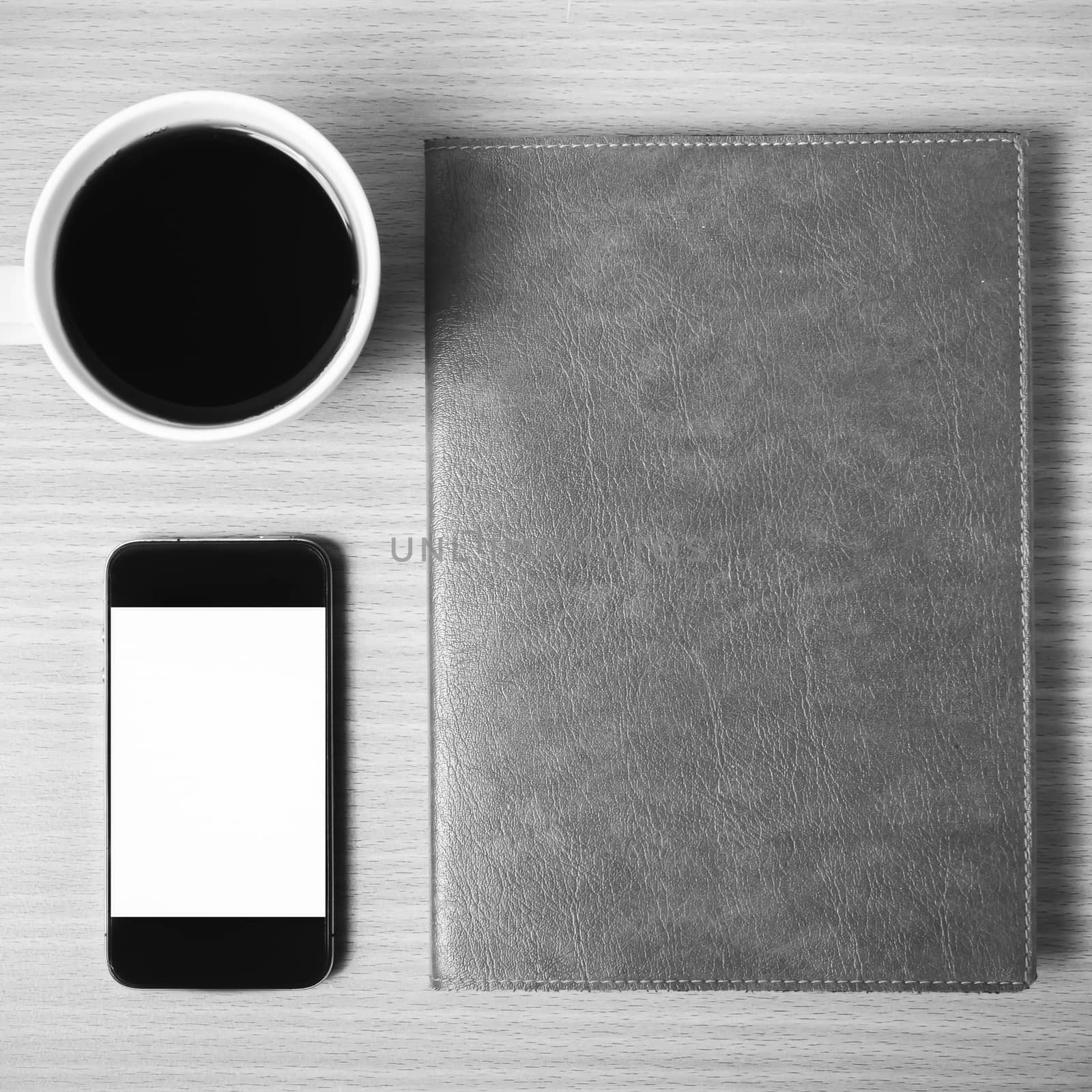 smart phone coffee cup and notebook on wood background black and white color tone style
