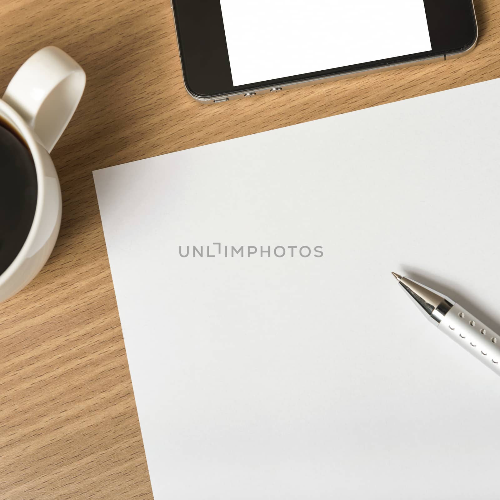 paper and pen with coffee cup and smart phone on wood background