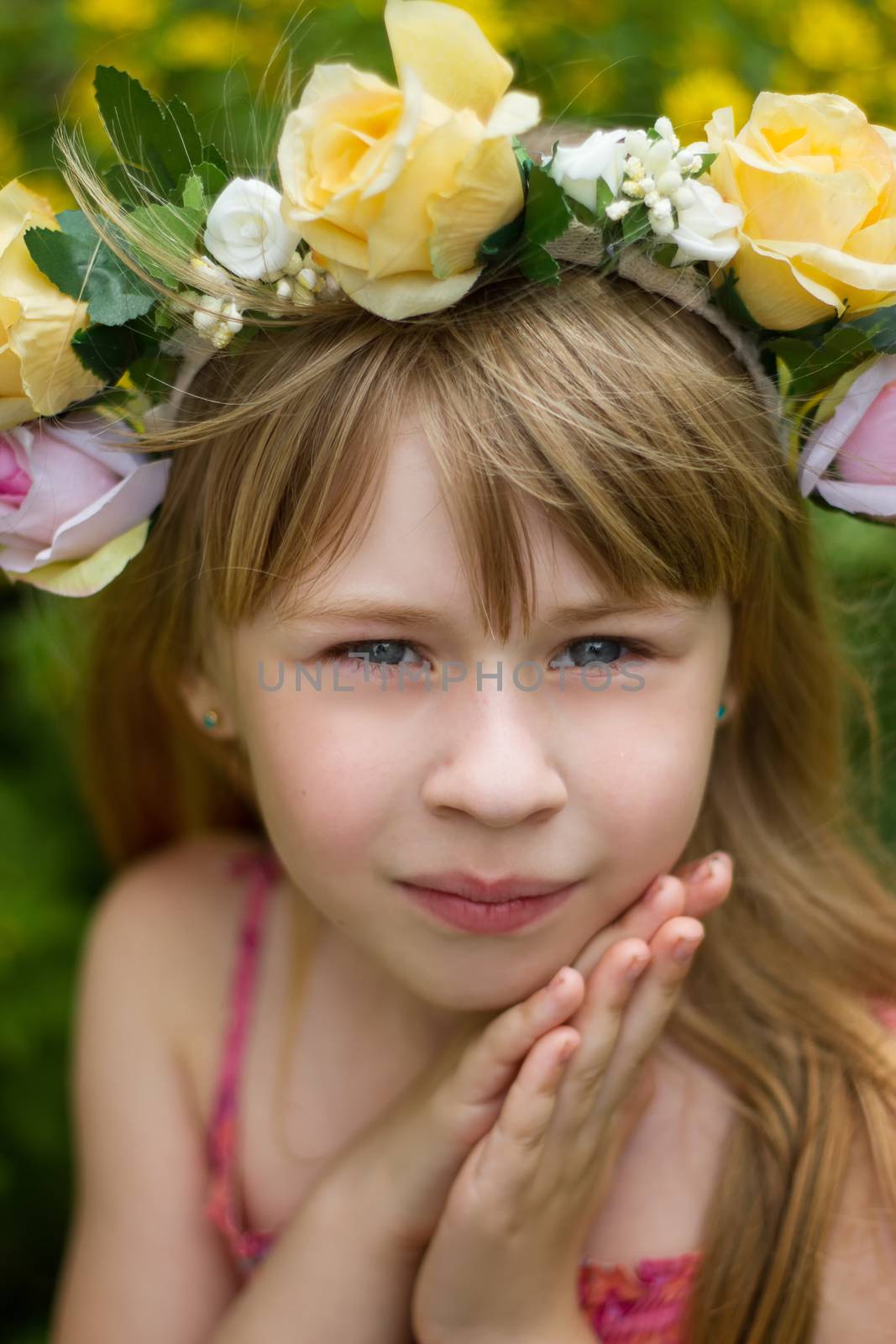 Closeup portrait 6 year old girl in a wreath