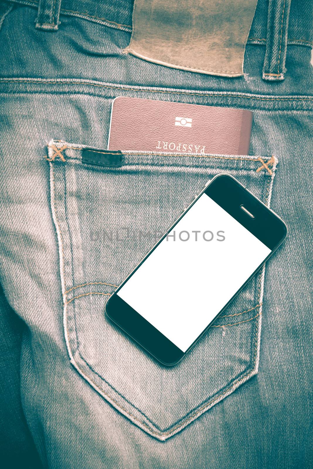 passport in jean pocket with smart phone retro vintage style