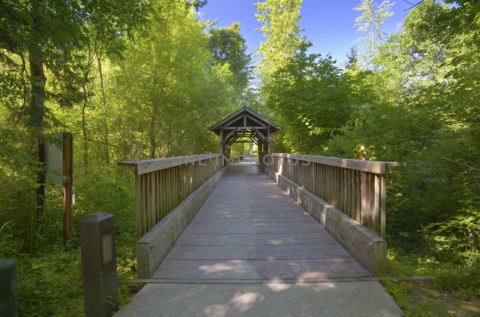 Small wooden covered bridge in Fairview Village Oregon.