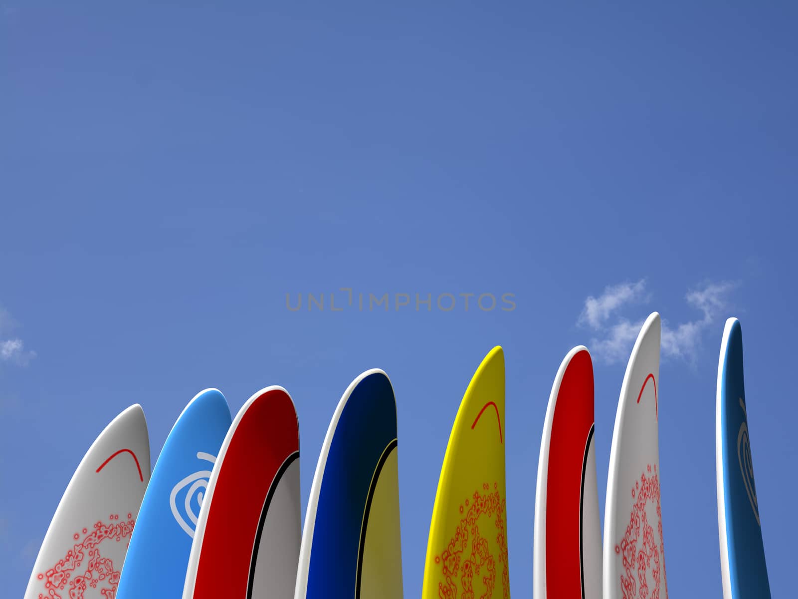 A set of surf boards vertically positioned with a blue sky and some clouds on the background