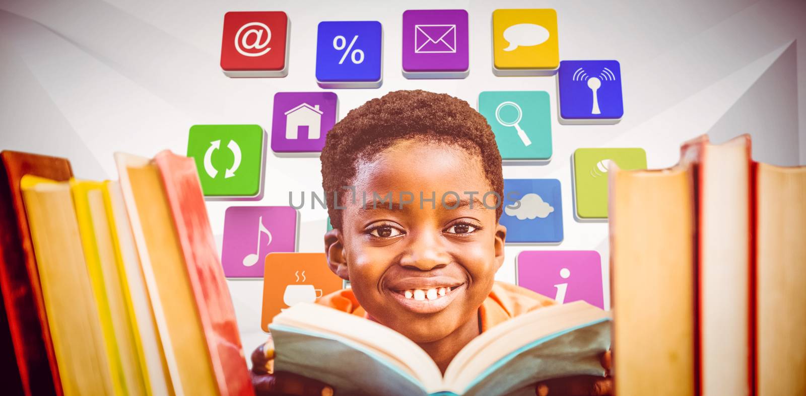 Composite image of cute boy reading book in library by Wavebreakmedia