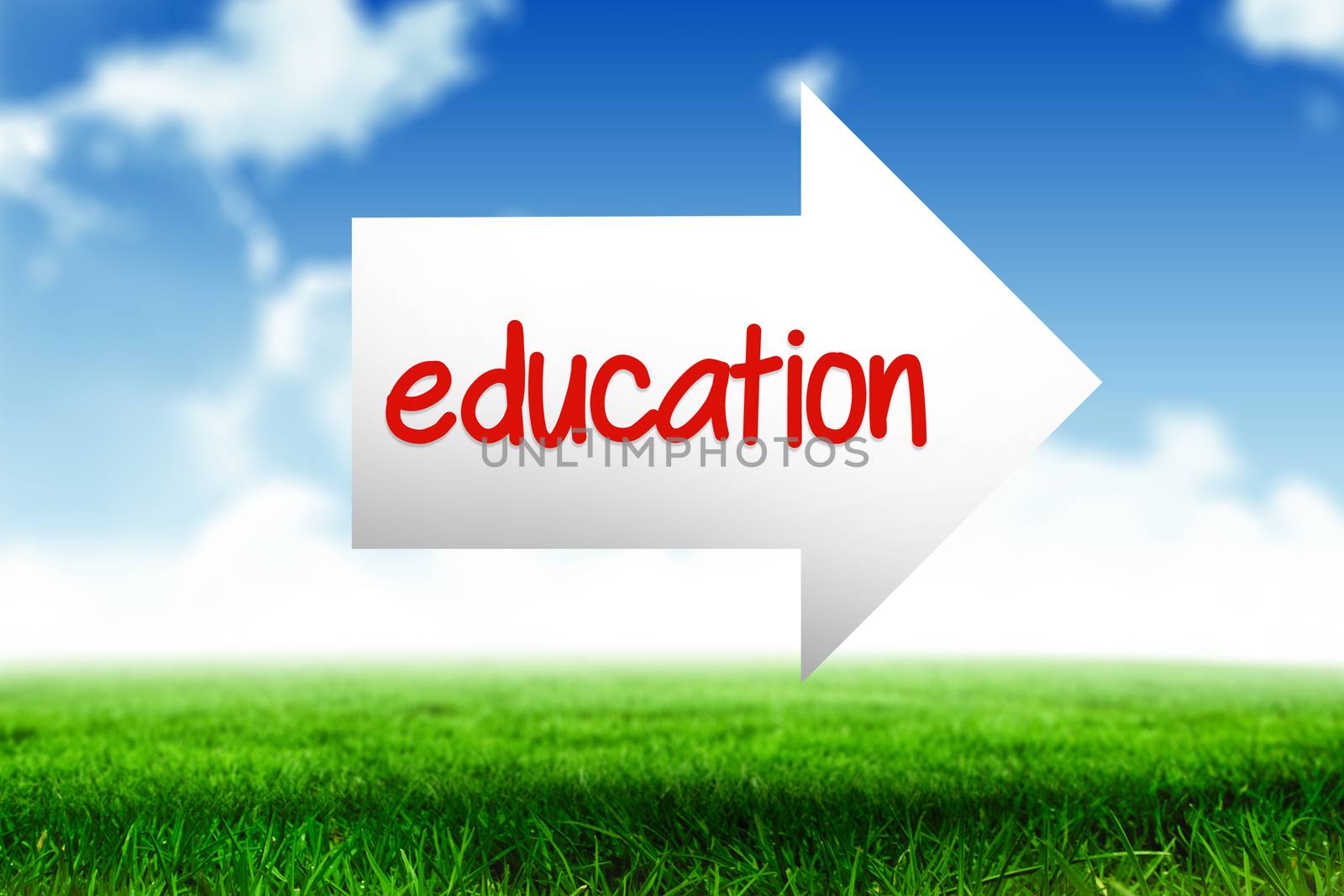 The word education and arrow against blue sky over green field