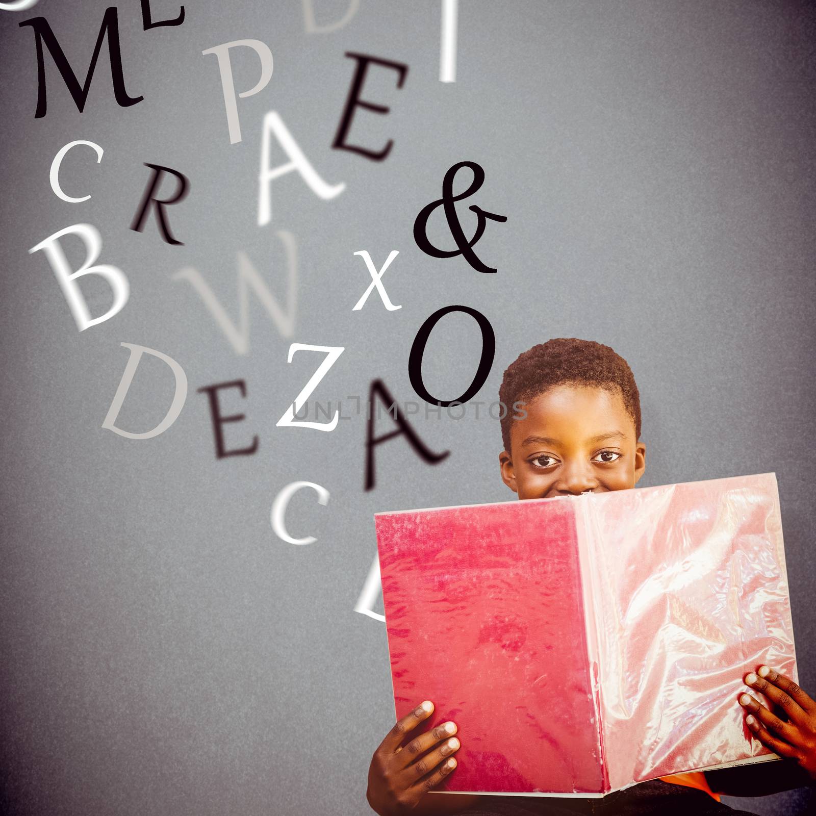 Composite image of cute boy reading book in library by Wavebreakmedia