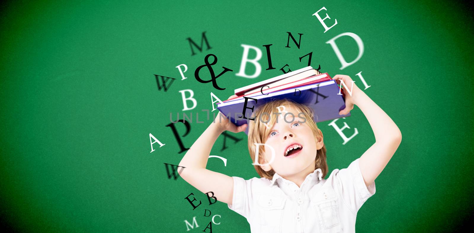 Cute pupil holding books against green