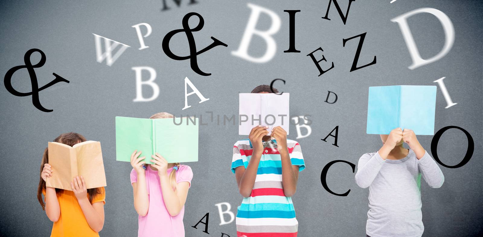 Composite image of elementary pupils reading by Wavebreakmedia