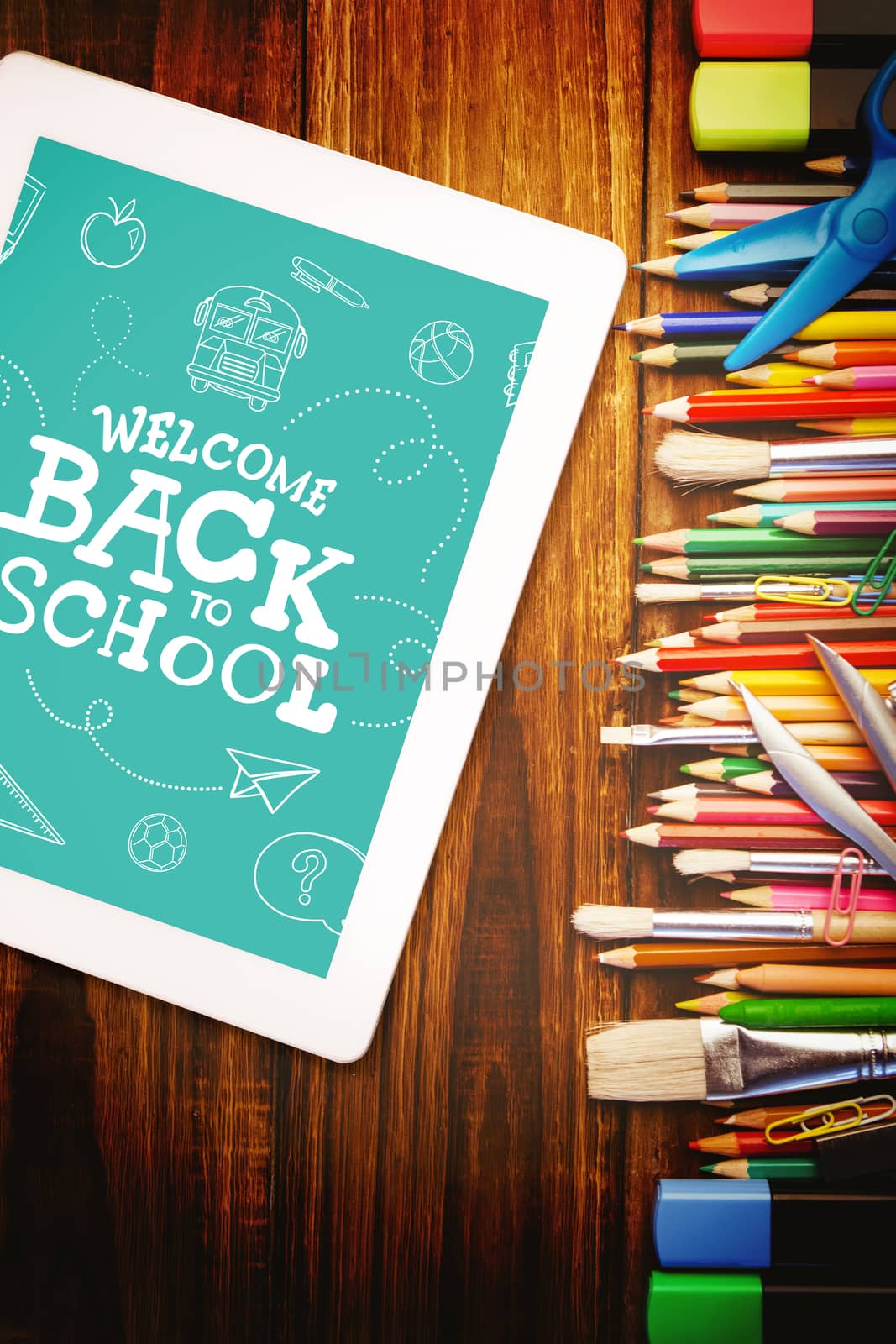 Back to school written on chalkboard against students desk with tablet pc