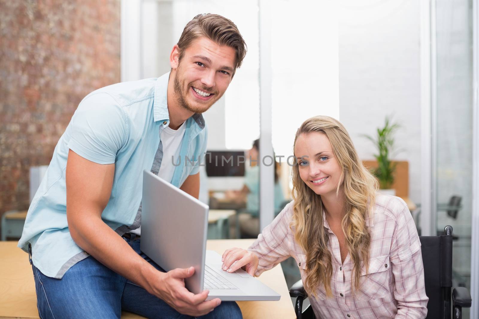 Business people smiling and working together with a laptop by Wavebreakmedia