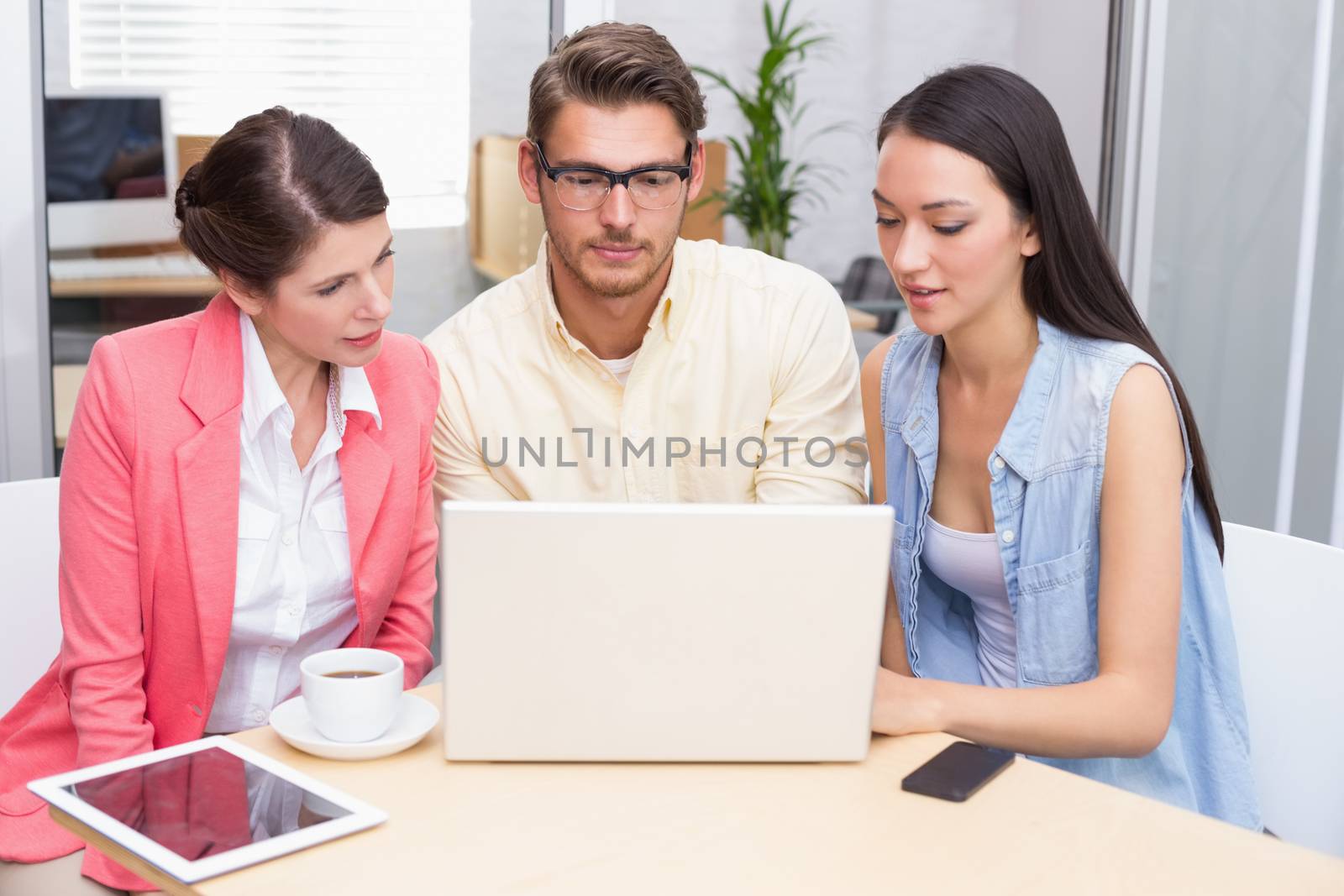 Business team using laptop and having coffee by Wavebreakmedia