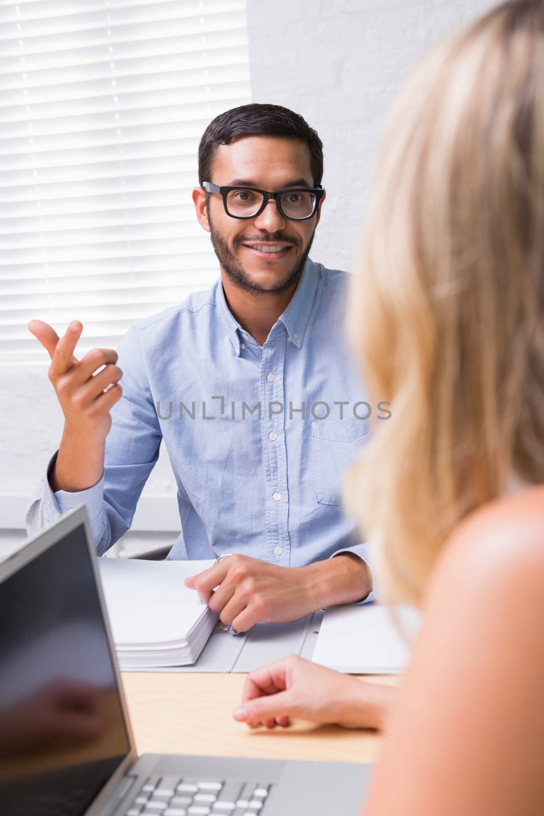 Young businessman interviewing woman in the office