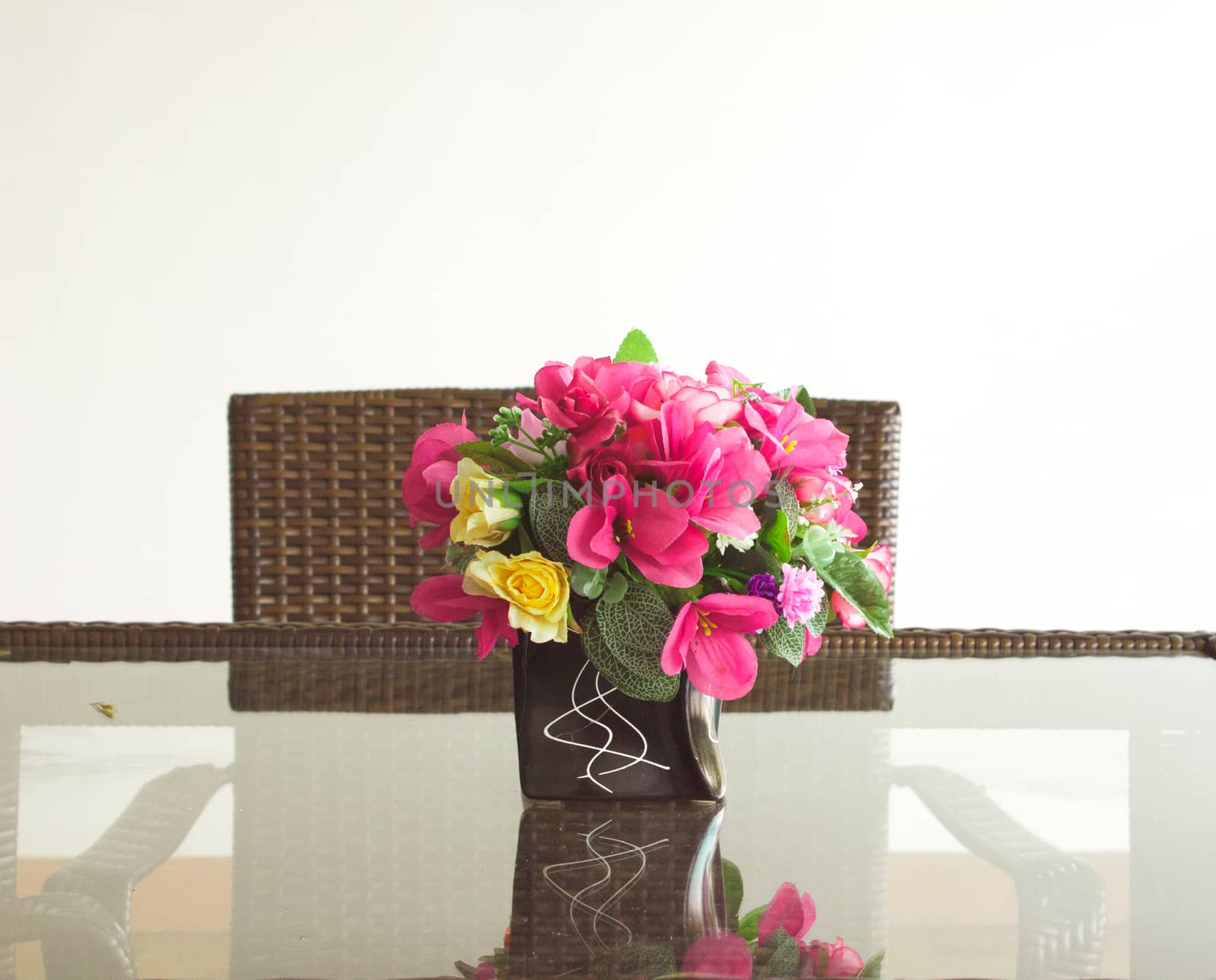 Vase of flowers on the glass table