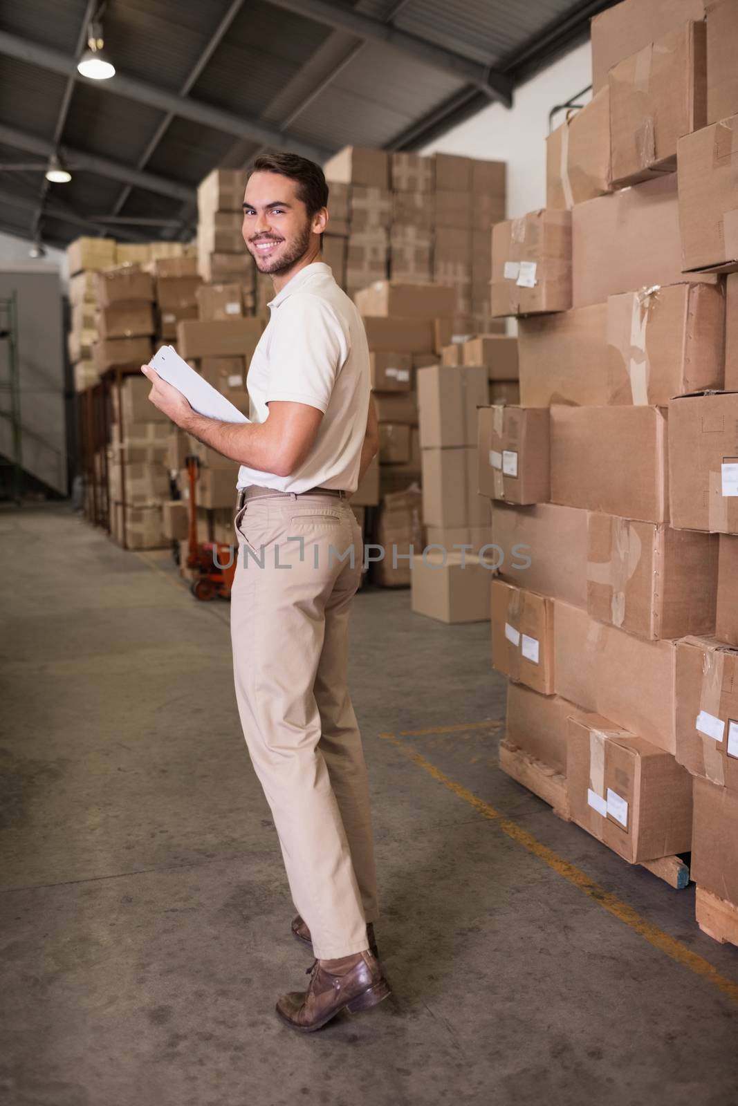 Portrait of warehouse worker with clipboard in warehouse