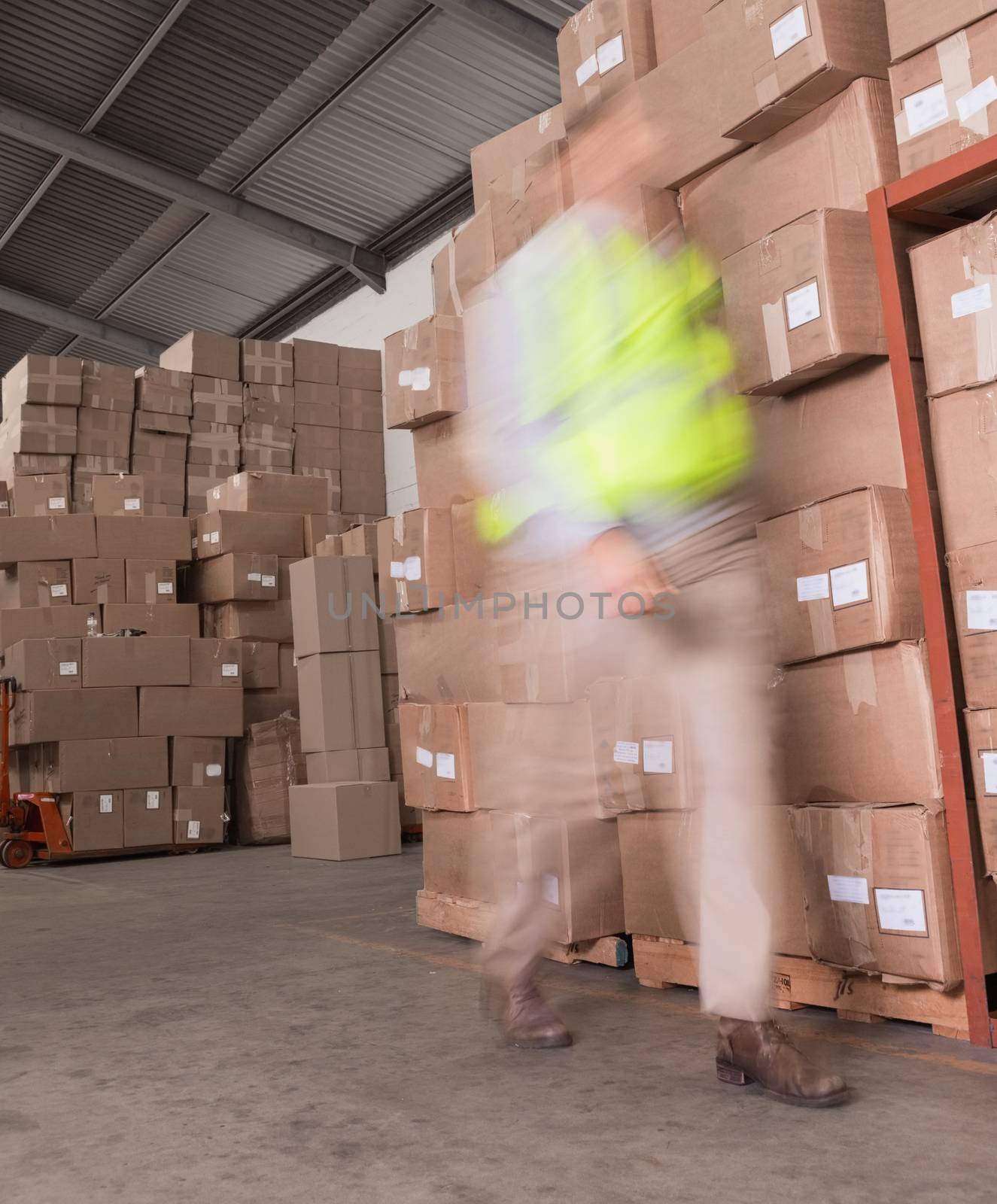Blurred worker walking in warehouse by Wavebreakmedia