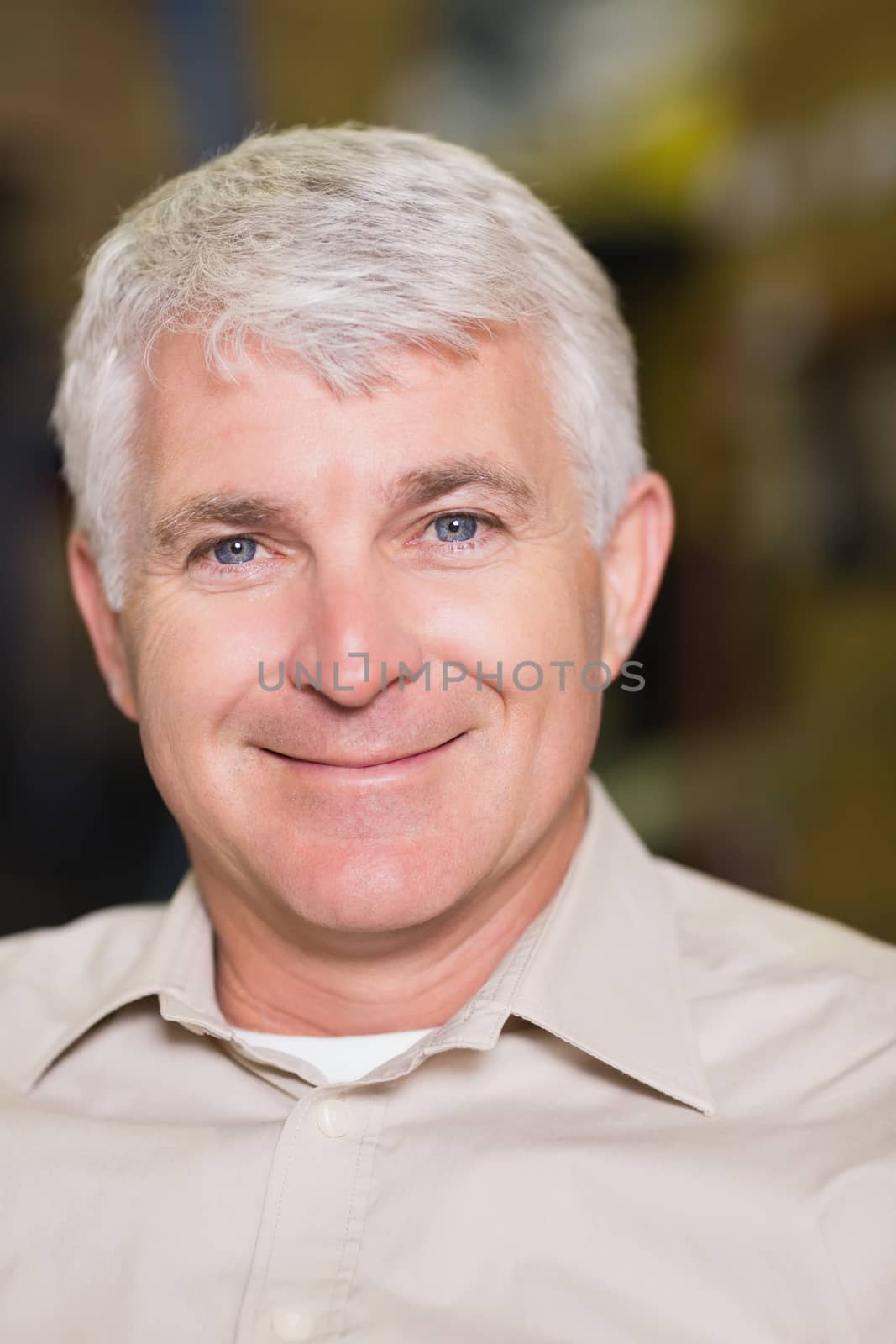 Close up portrait of a smiling workman in warehouse