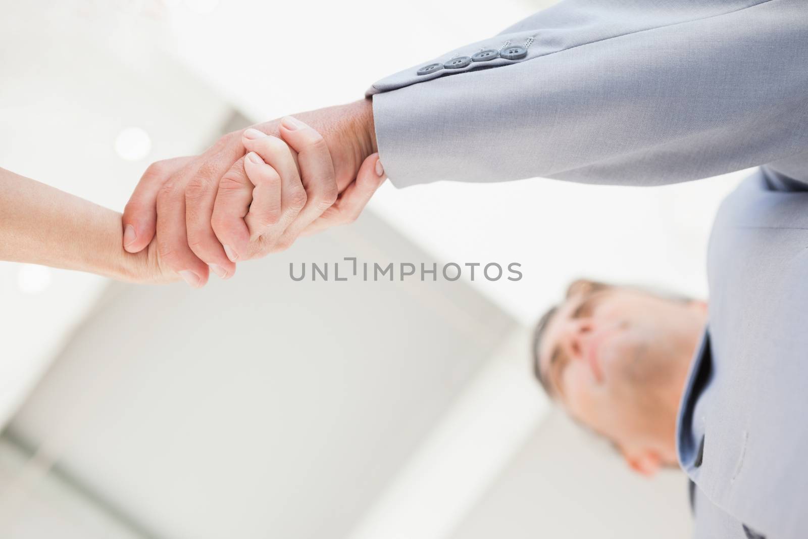 Two business people shaking hands in agreement