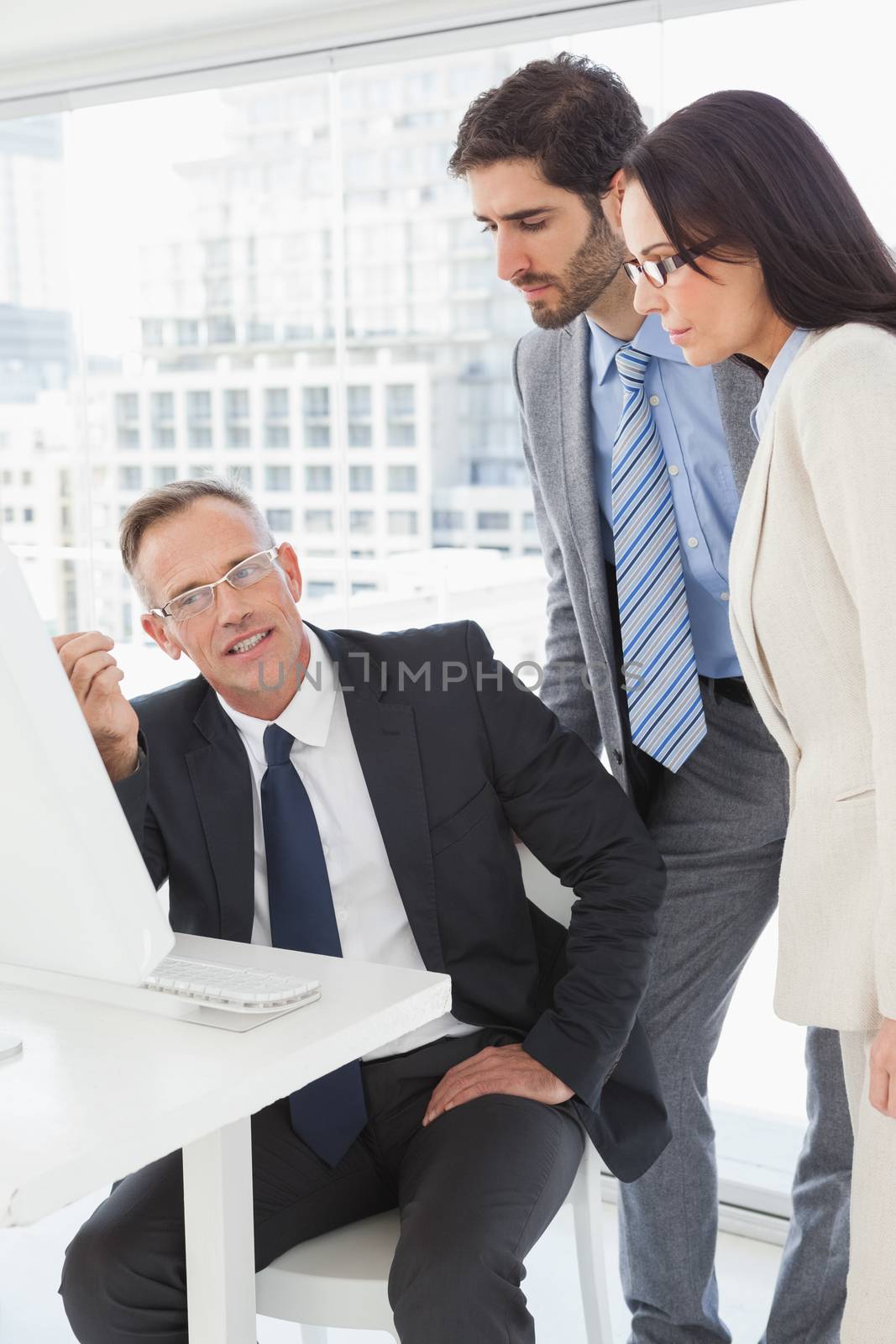 Business people looking at a computer in the office