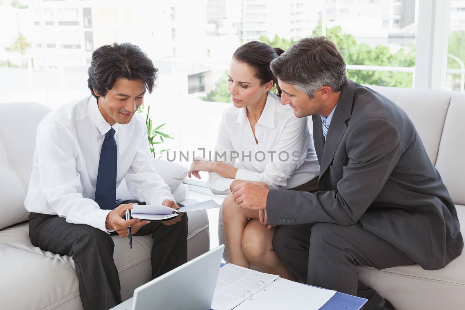 Business team looking over notes while sitting down