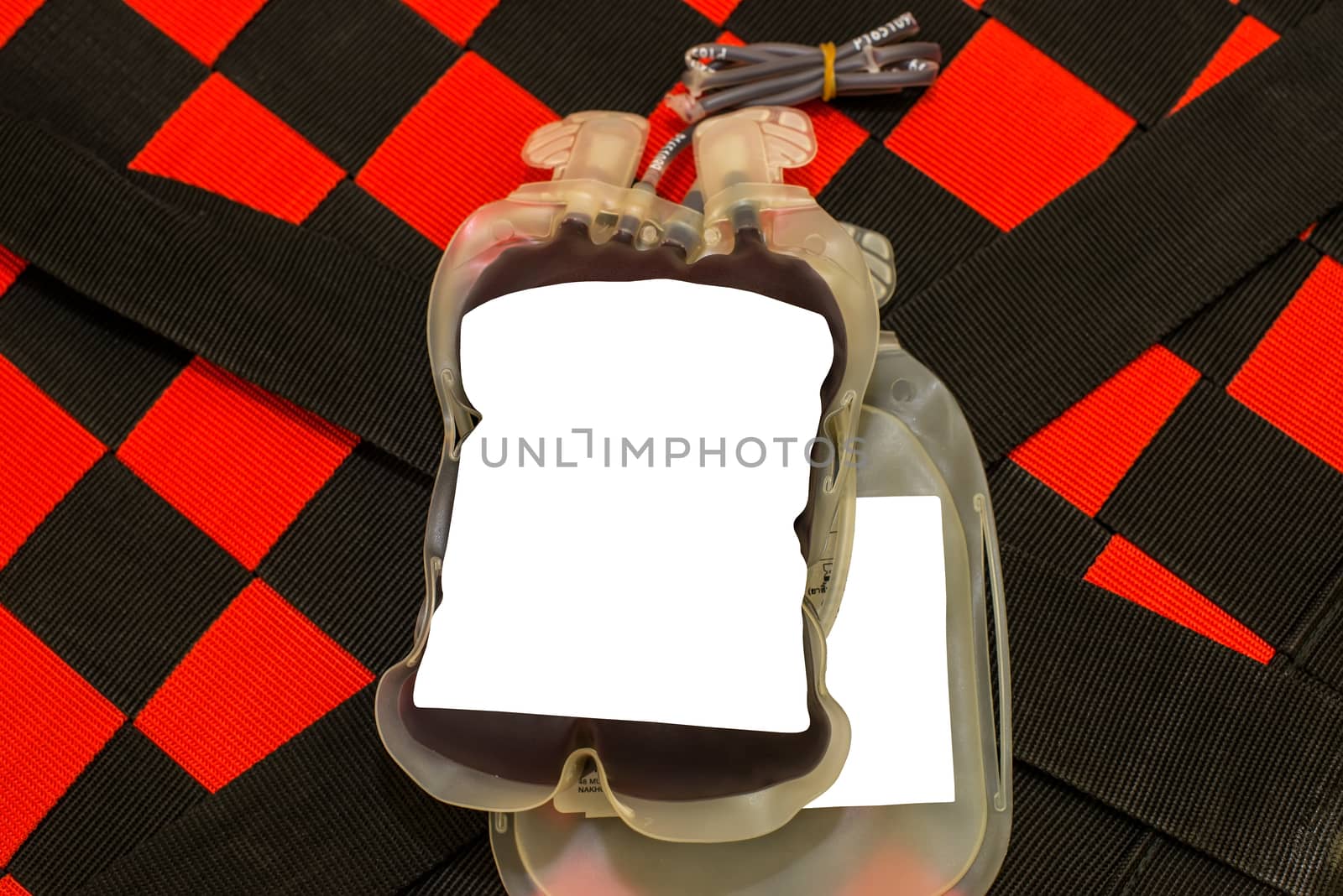 Close up bag of blood and plasma and rubber tube isolated on Red background