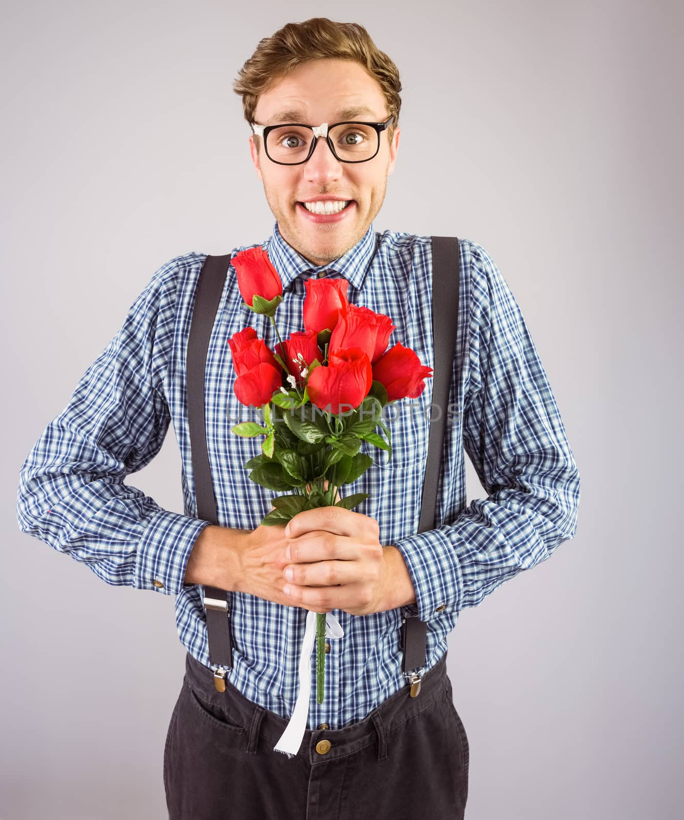 Geeky hipster holding a bunch of roses by Wavebreakmedia