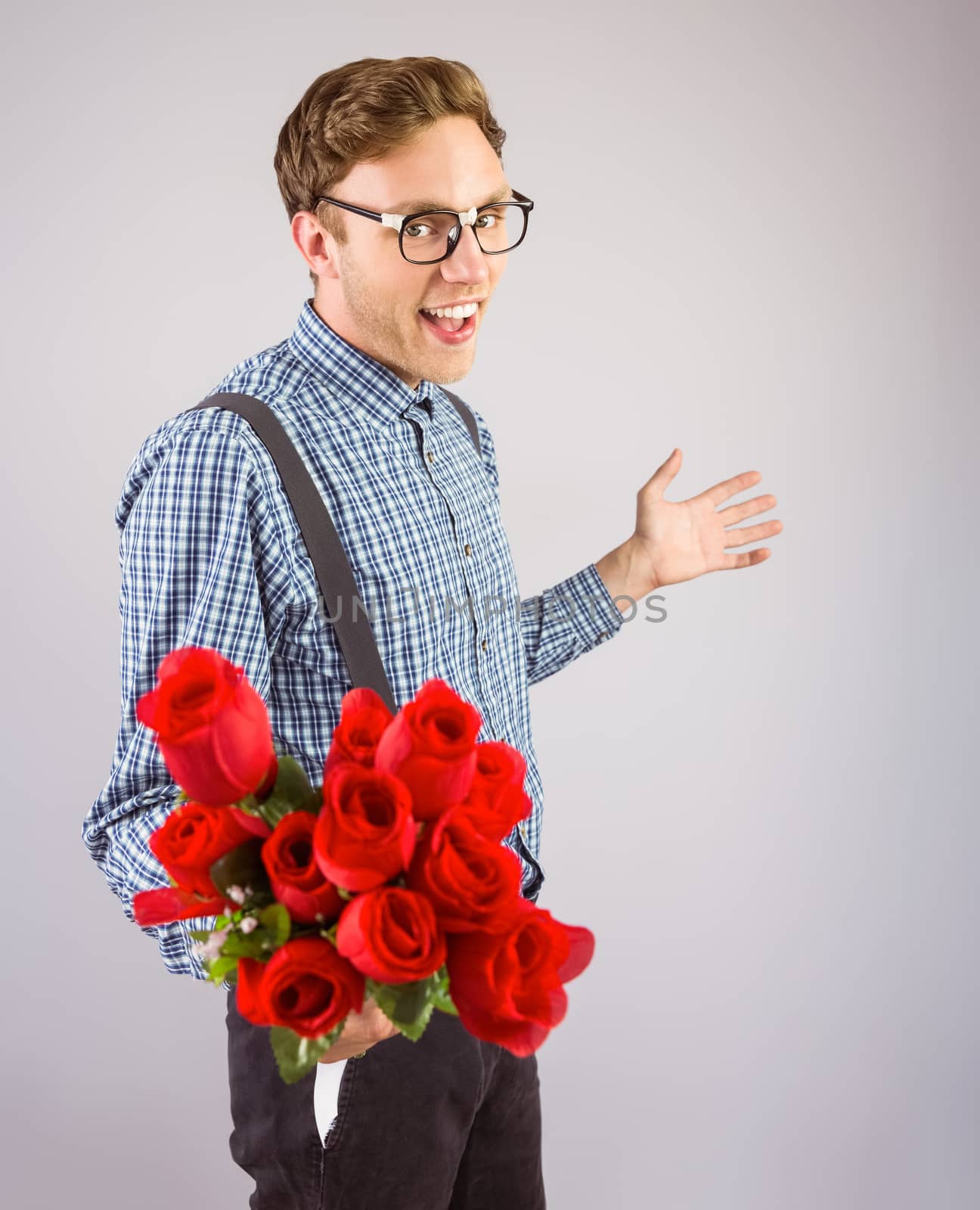 Geeky hipster holding a bunch of roses by Wavebreakmedia