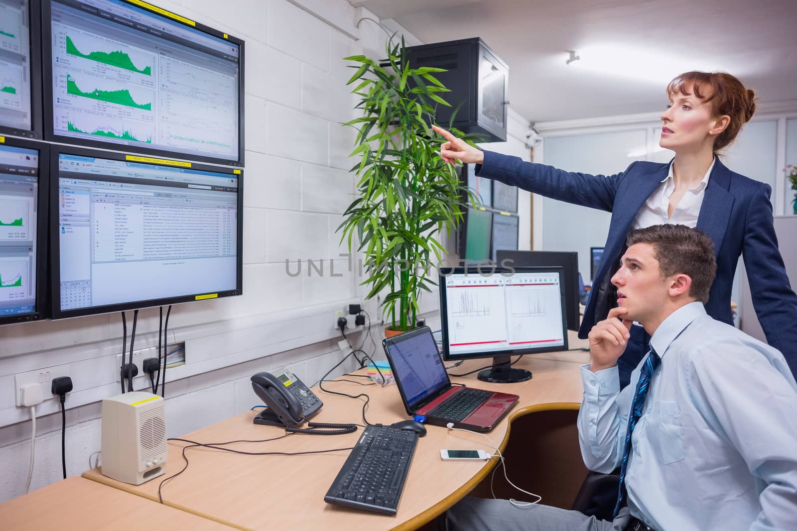 Focused colleagues analyzing result on their computer by Wavebreakmedia