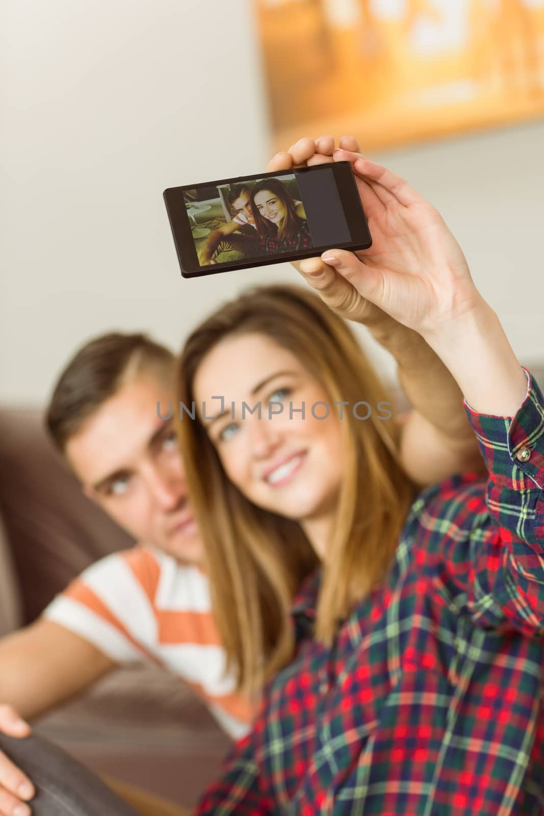 Cute couple taking a selfie at home in the living room