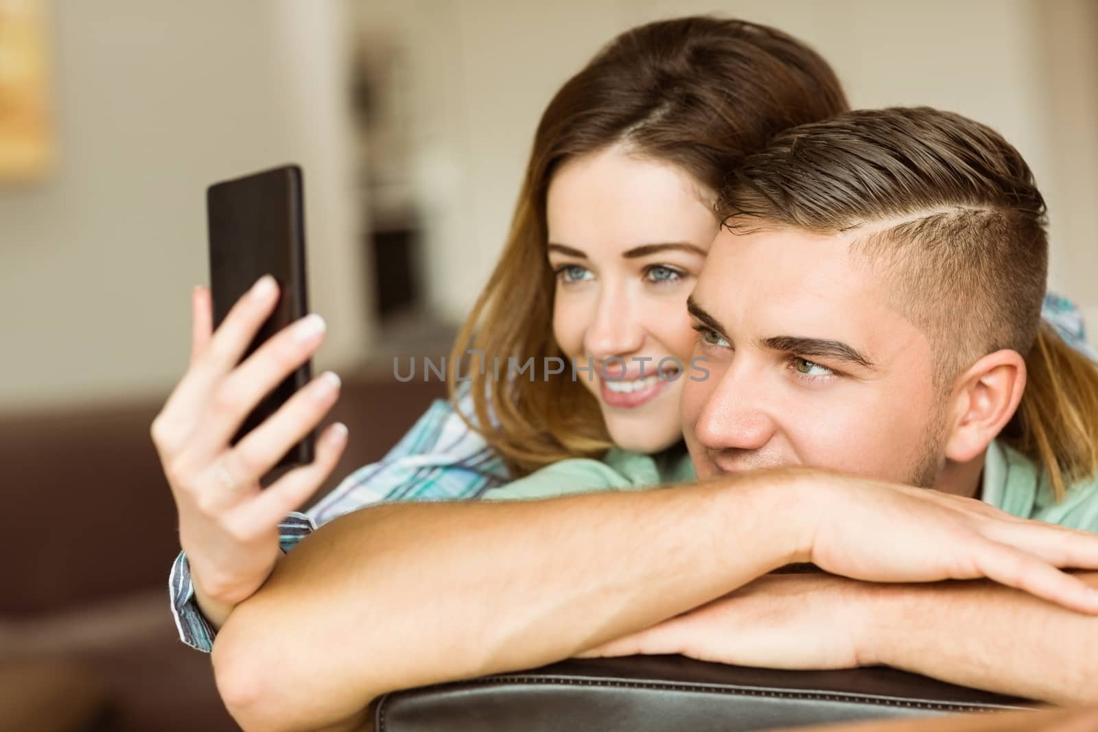 Cute couple taking a selfie at home in the living room