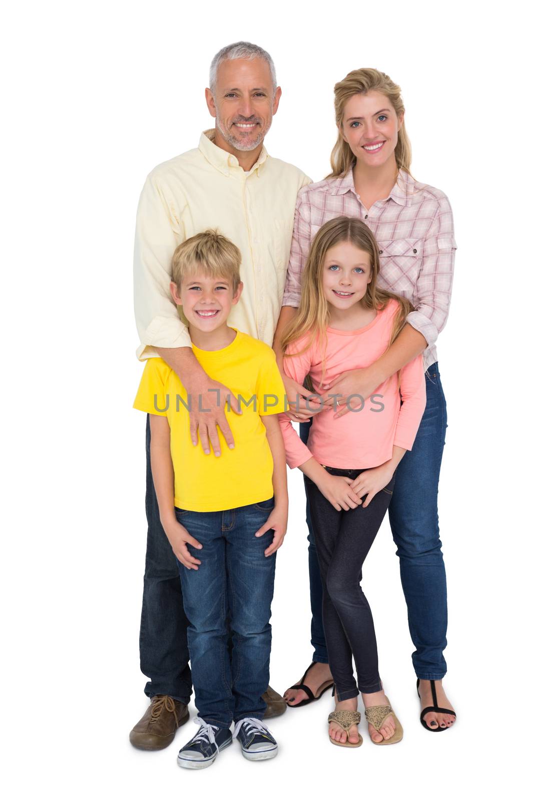 Happy family smiling at camera by Wavebreakmedia