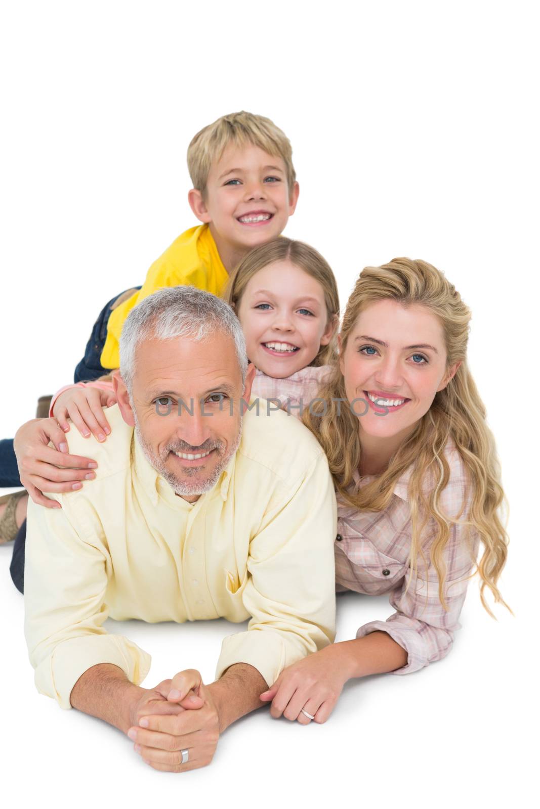 Happy family lying and smiling on white background