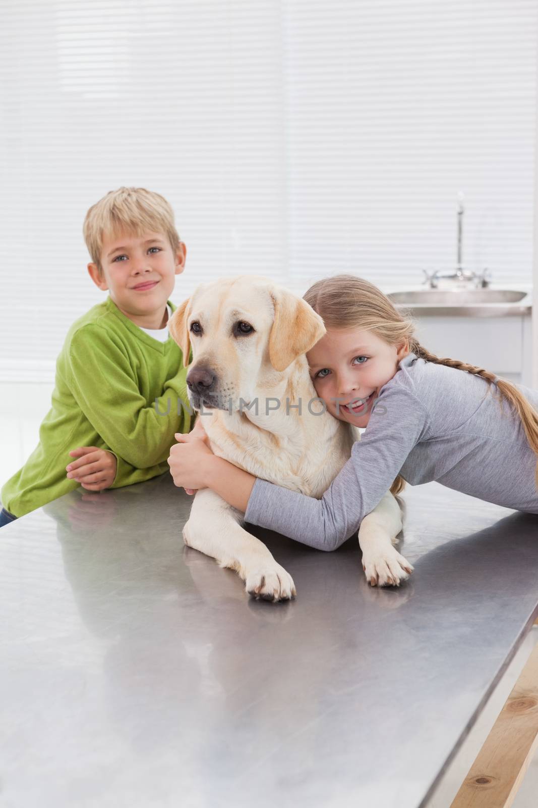 Cute labrador with its cheerful owners