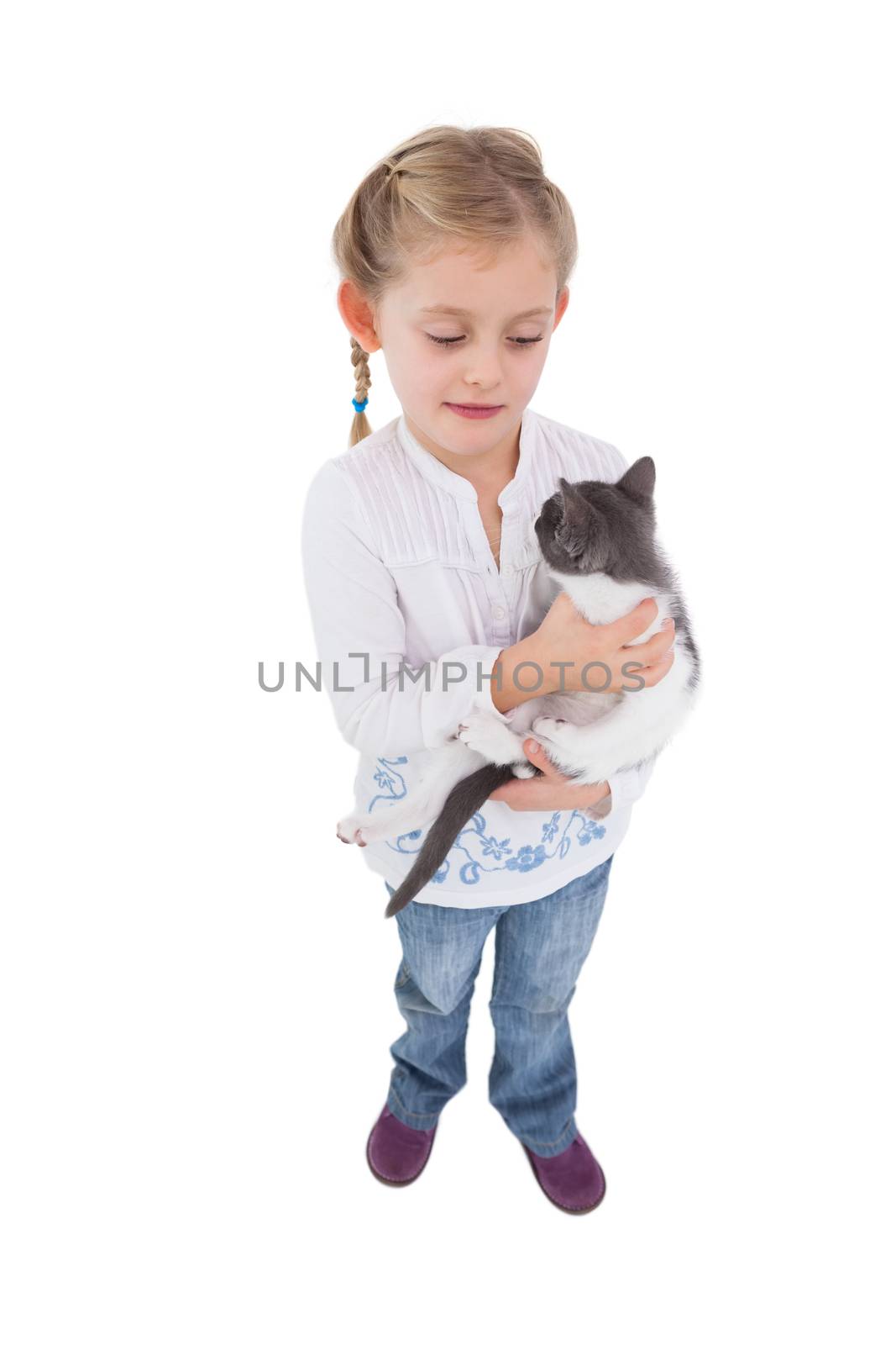 Pretty little girl with her cute kitten on white background 