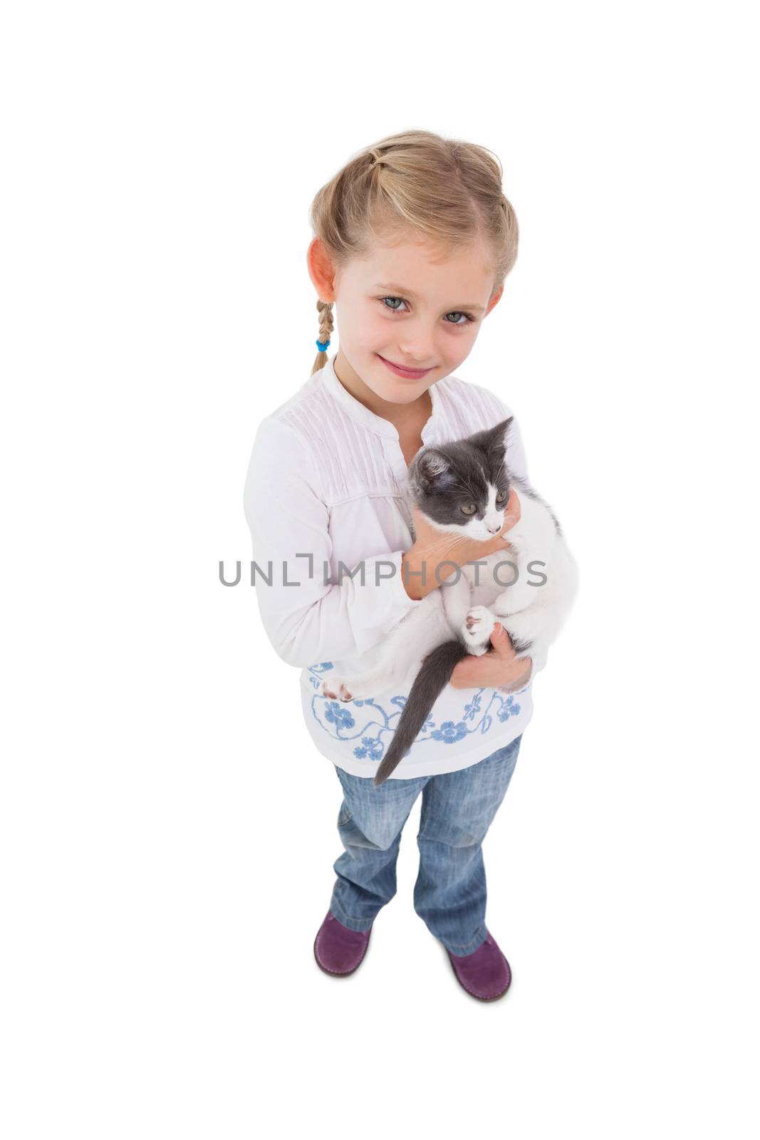 Smiling little girl with her cute kitten on white background