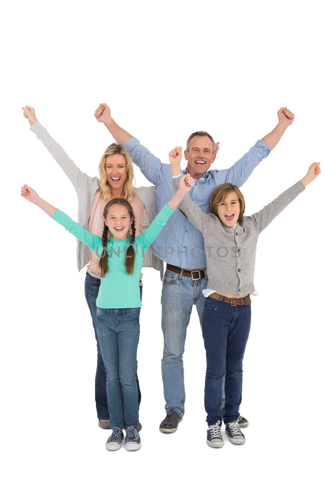 Smiling family raising their arms on white background