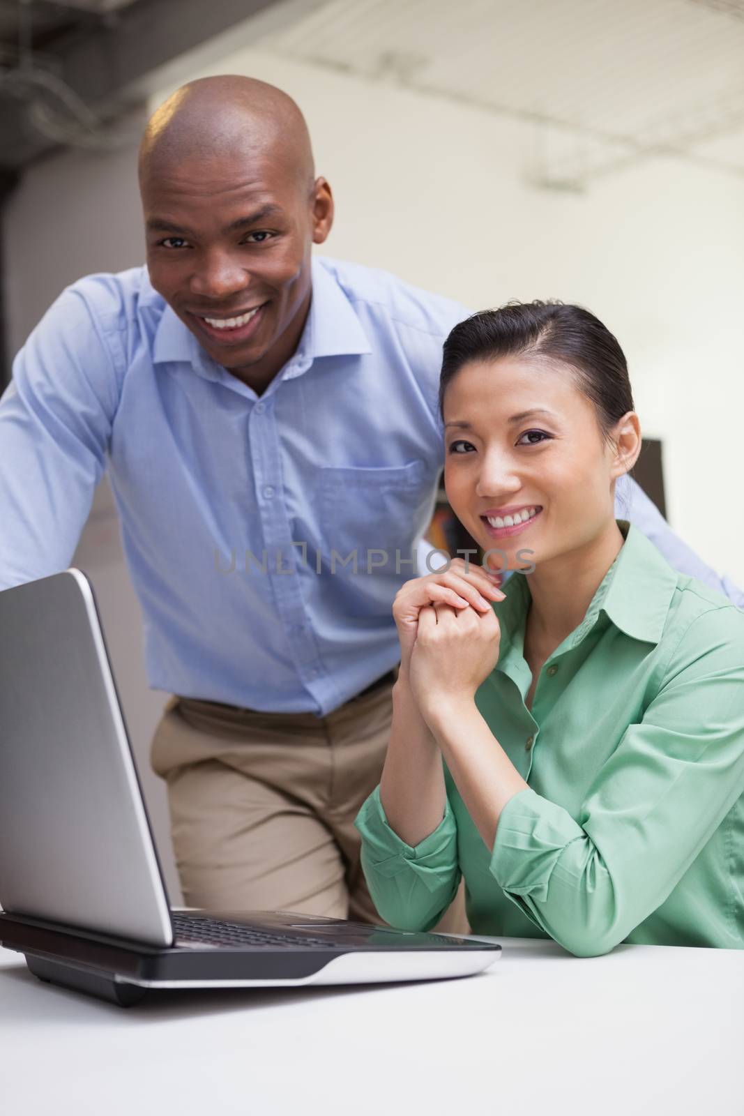 Casual business team working together with laptop in the office